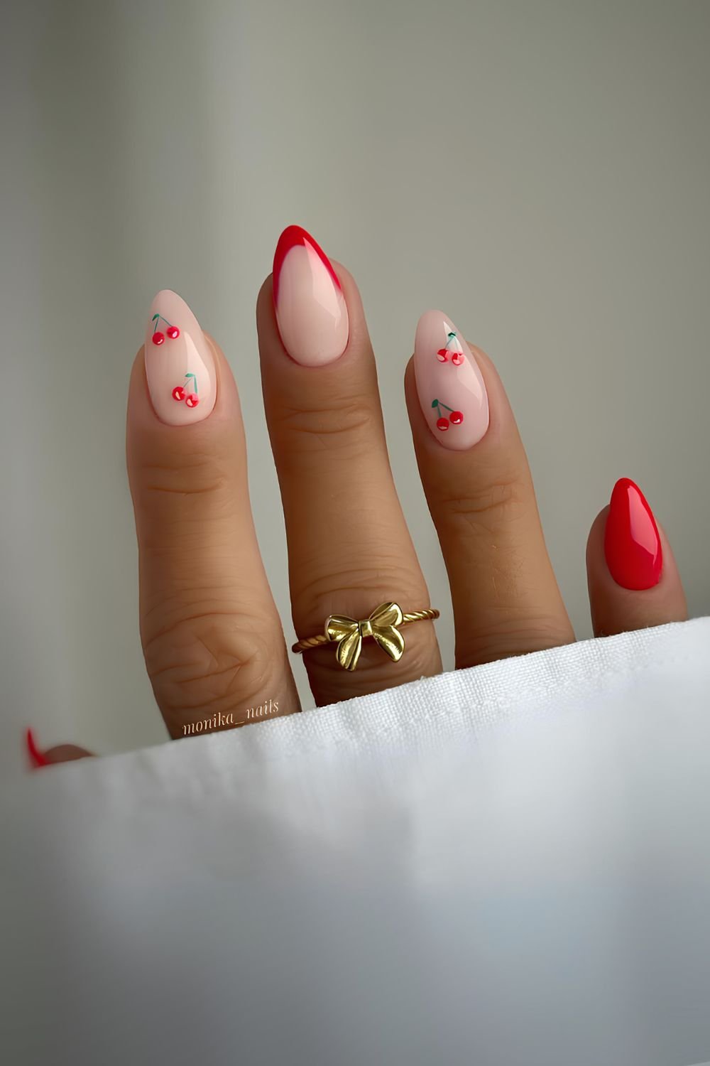 Milky nails with bright red French tip, solid and cherry accents