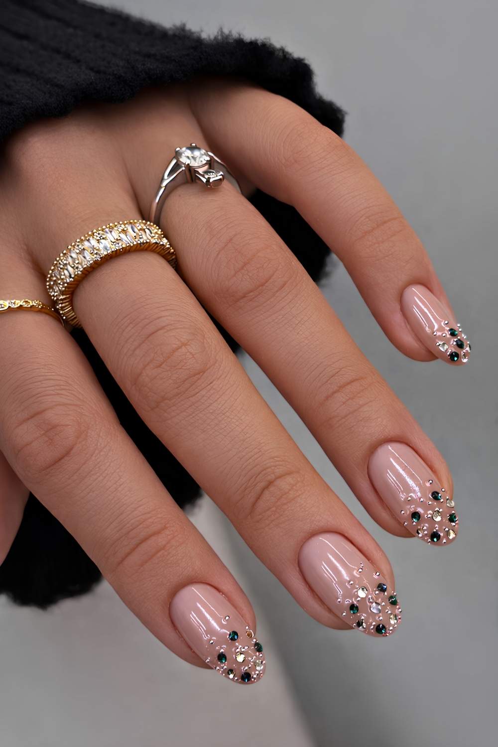 Milky nails with dark green and blue rhinestones