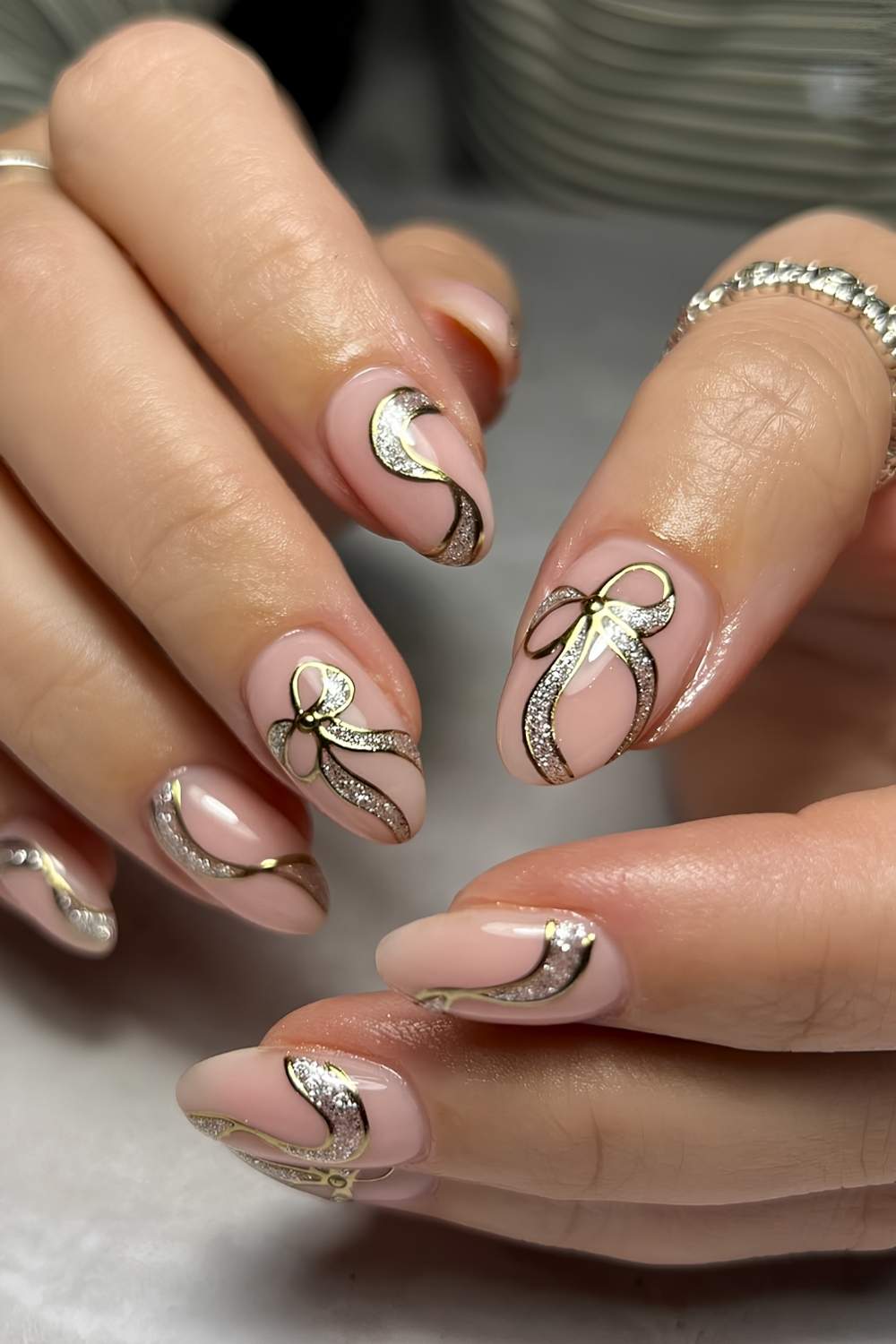 Milky nails with glittery gold bow art