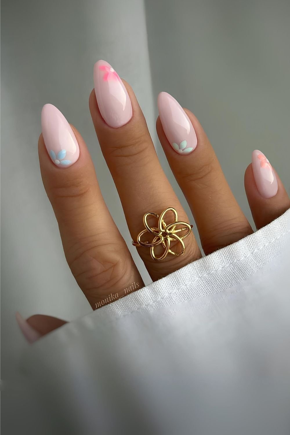 Milky nails with pastel floral accents and glazed finish