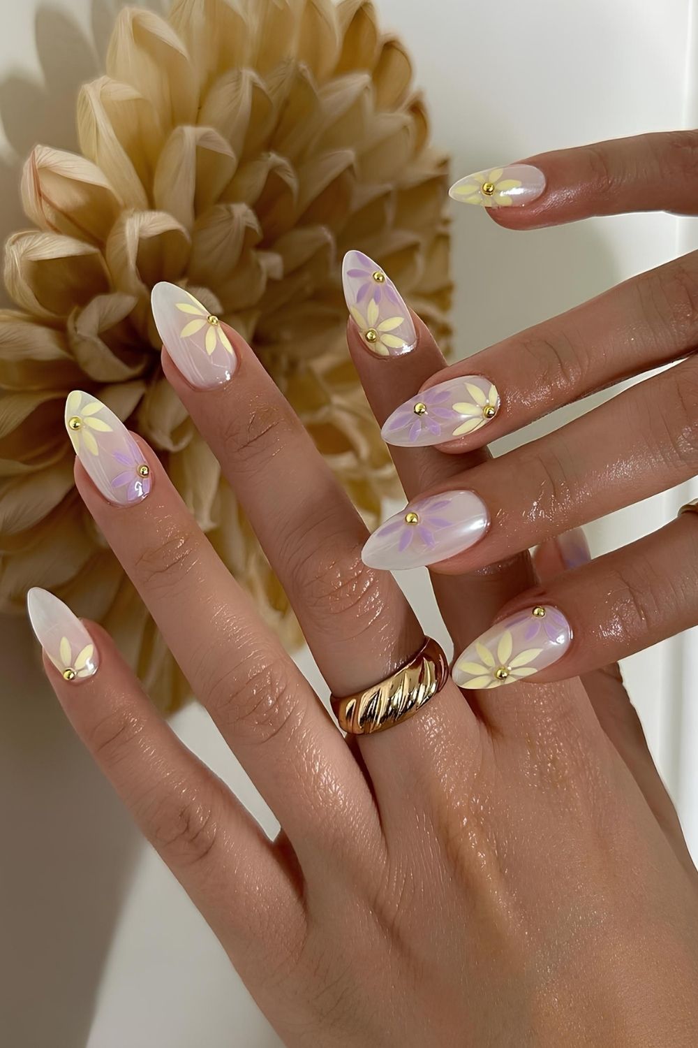 Milky nails with pastel floral and rhinestone accents and glazed finish