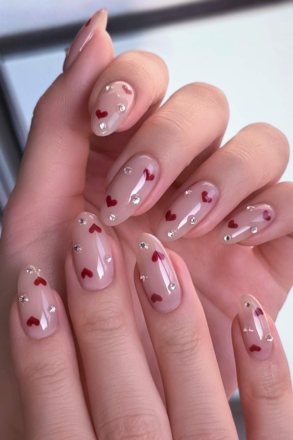 Milky nails with red hearts and gems
