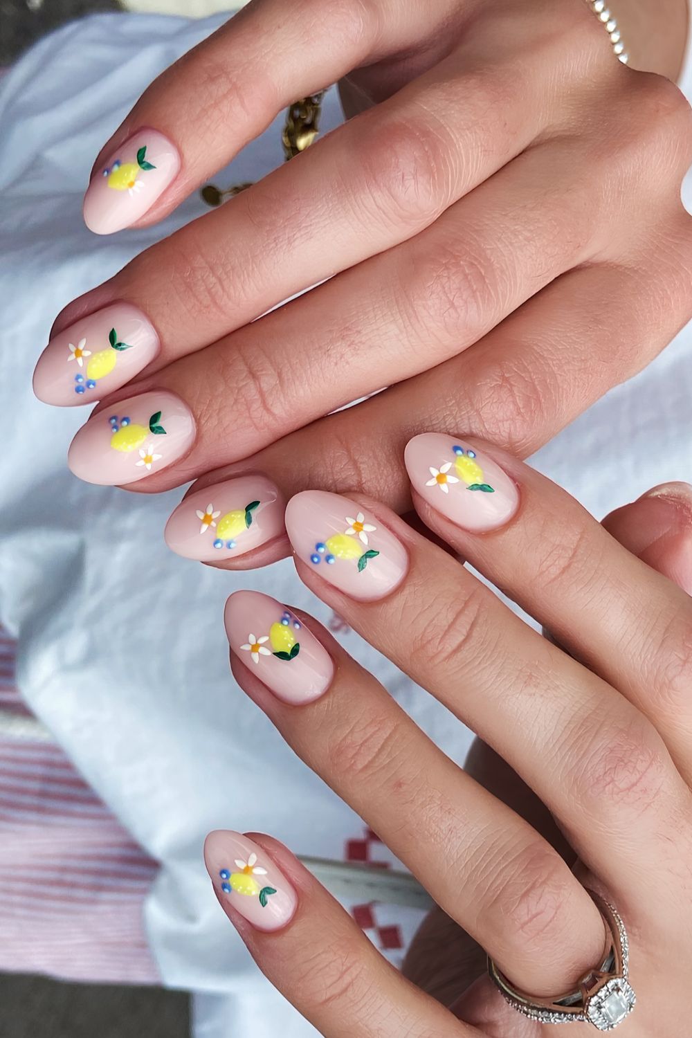 Milky pink nails with floral and fruit art