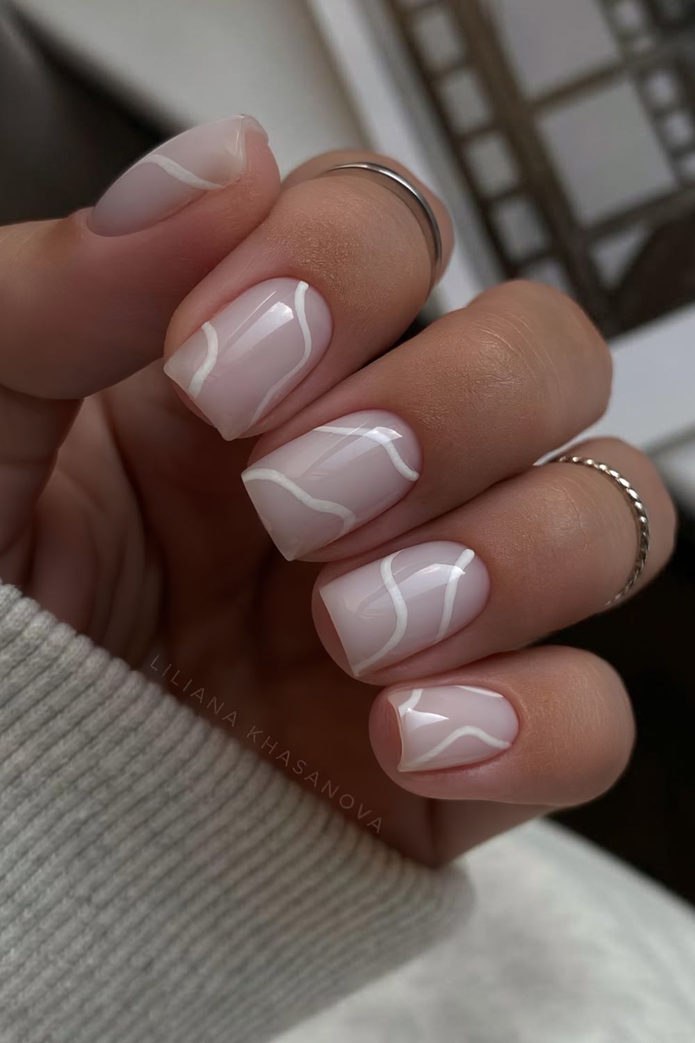 Milky white manicure with thin swirls