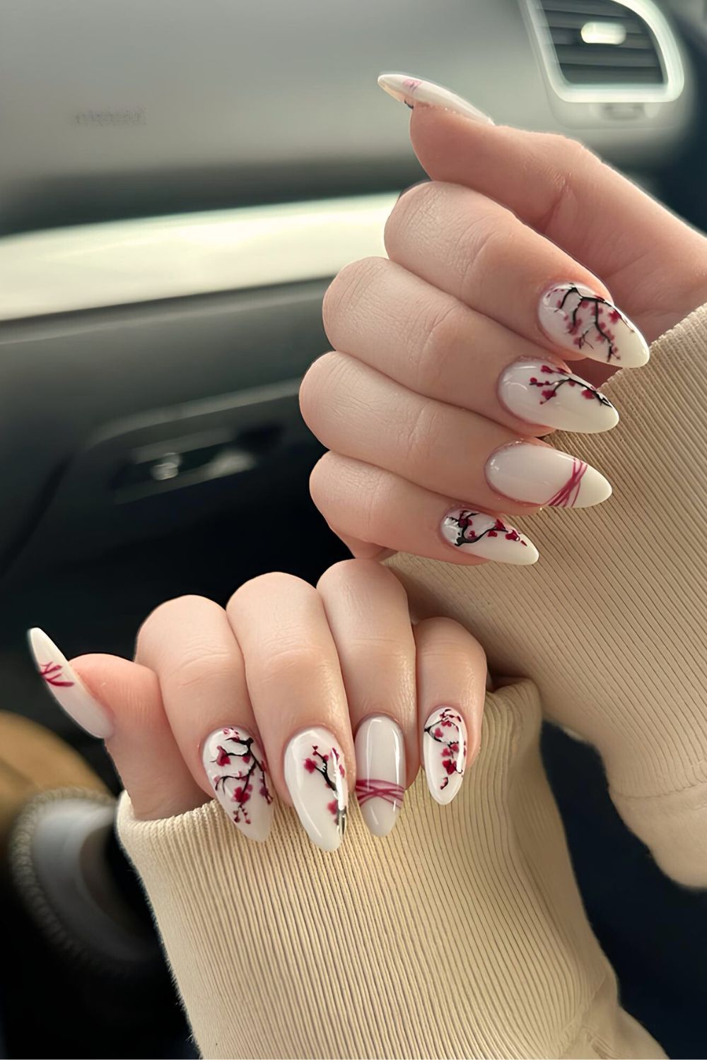 Milky white nails with cherry blossom accents