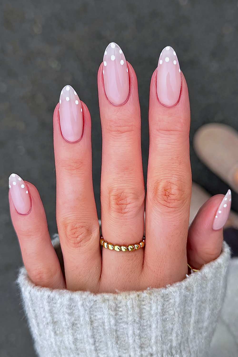 Milky white nails with polka dots at the tips