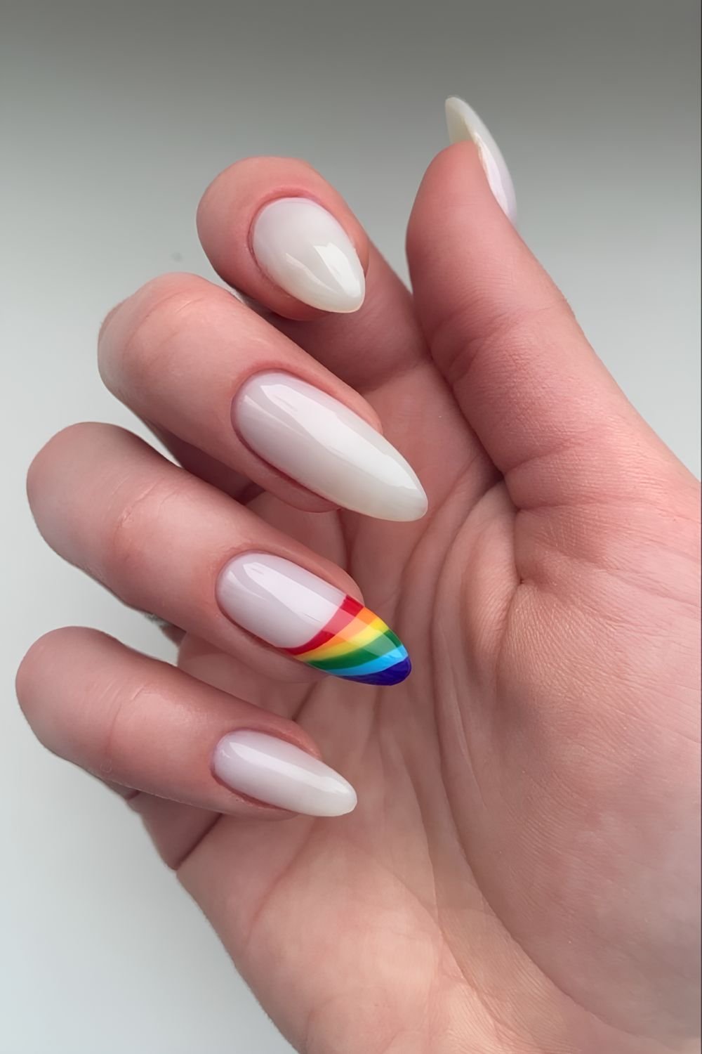 Milky white nails with pride flag accent tip