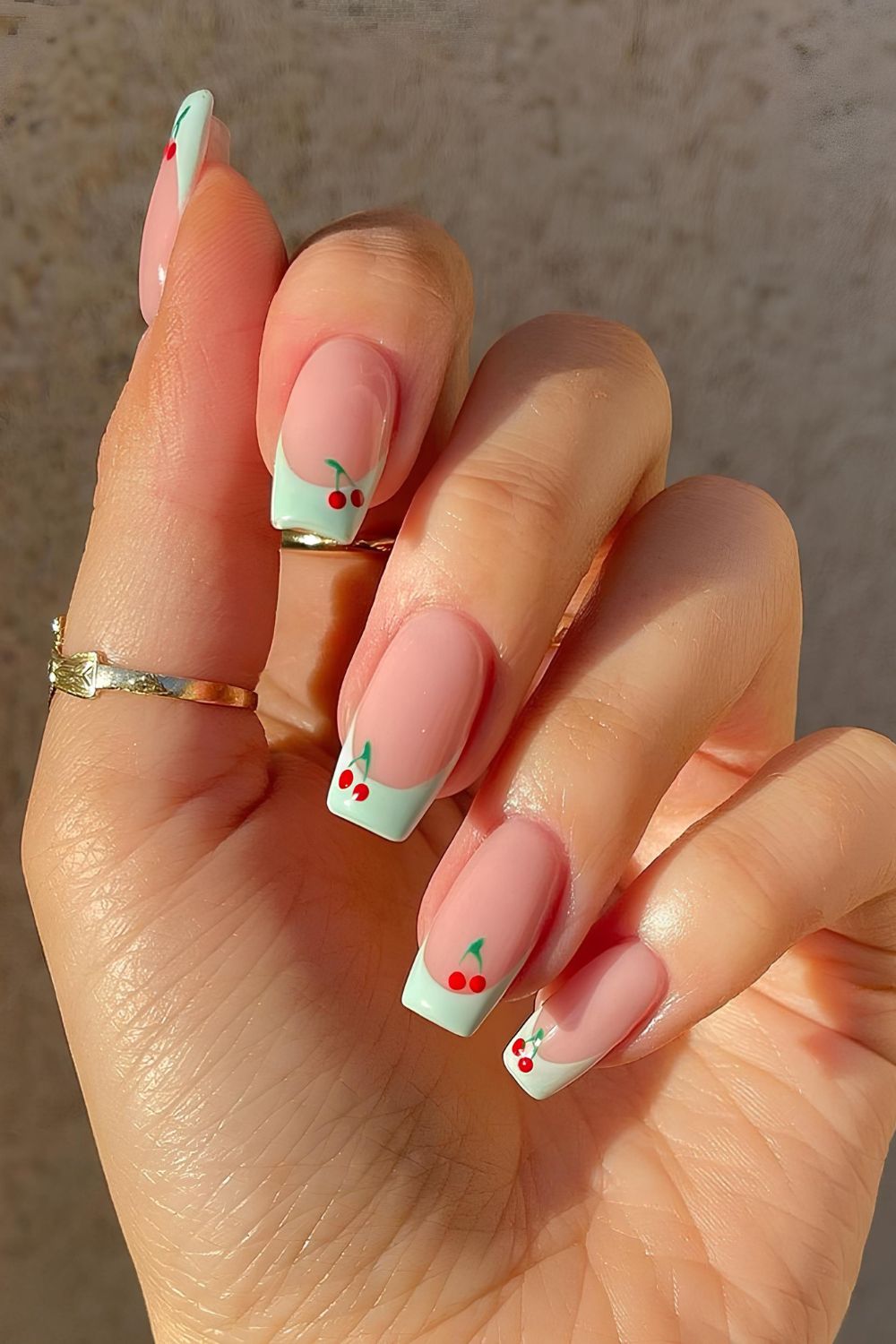 Mint French nails with cherry accents