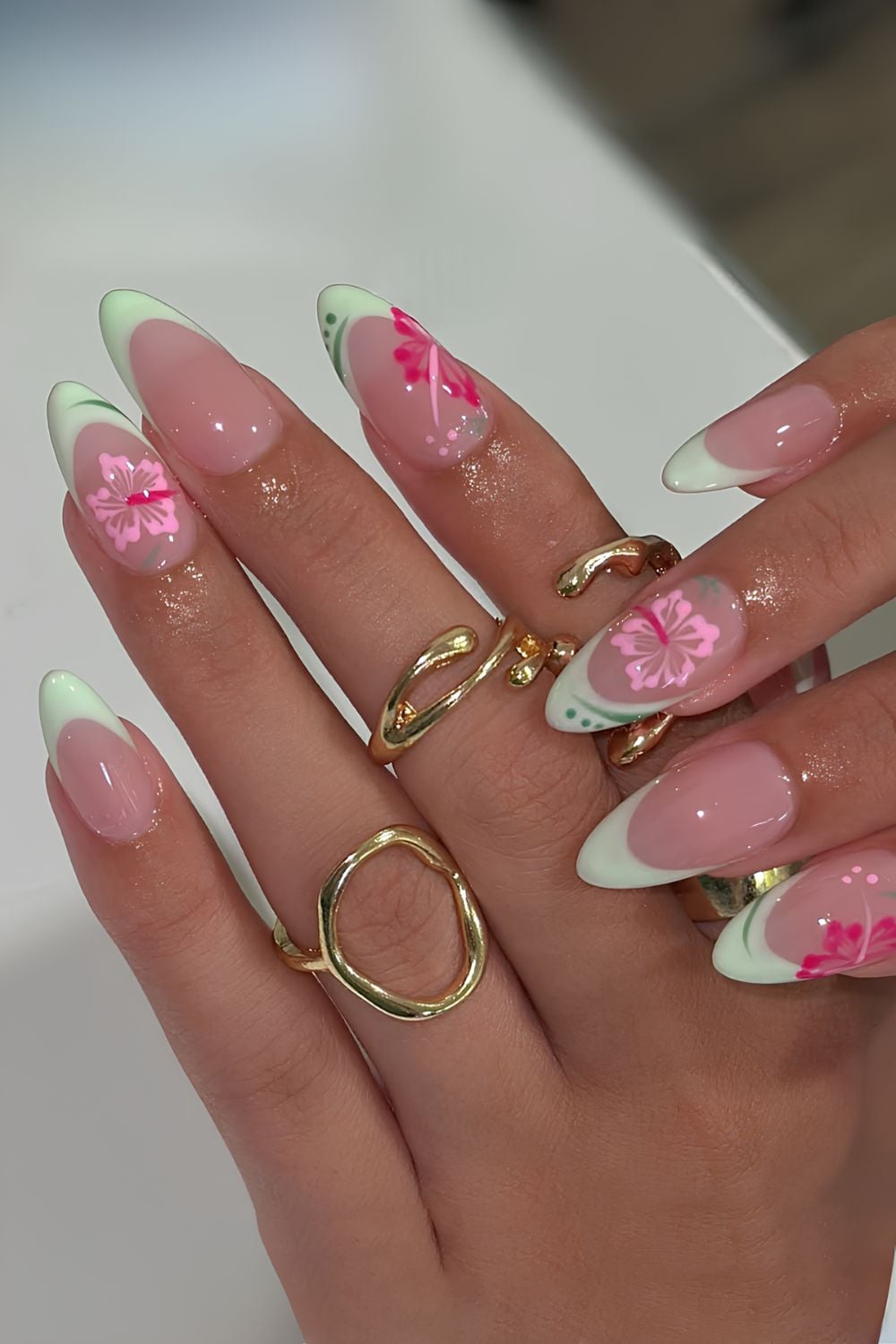 Mint green french tips with pink hibiscus flower accents