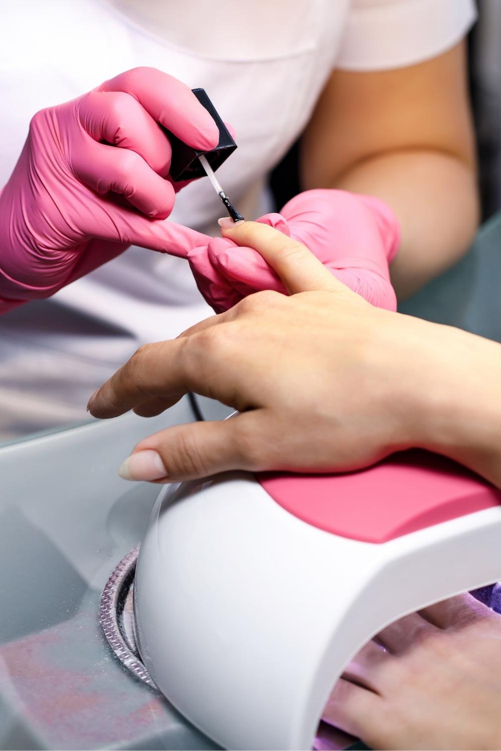 Nail tech applying gel polish