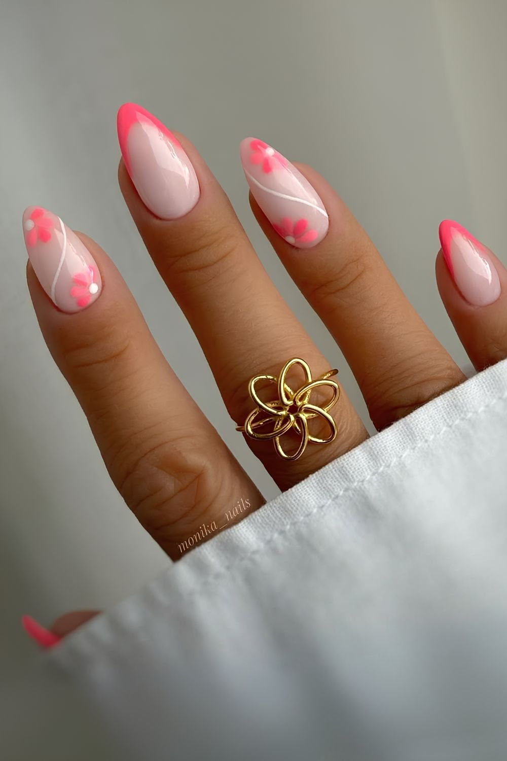 Neon pink French nails with flowers and swirls
