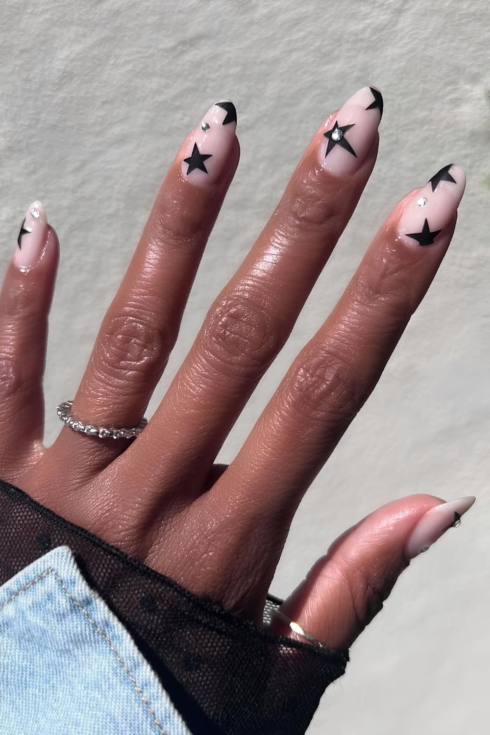 Neutral mani wih black stars and gems