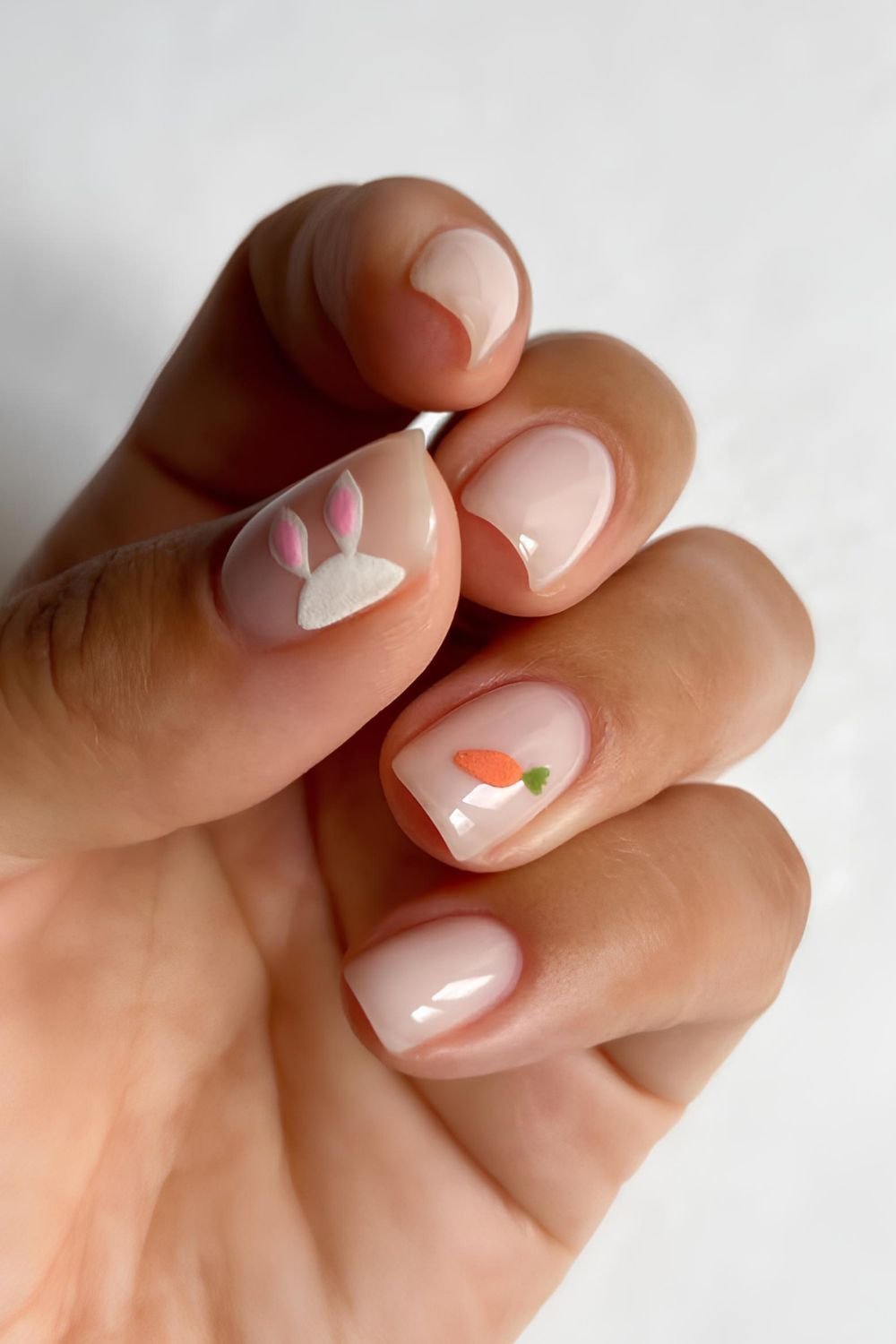 Neutral milky nails with bunny ears accent and tiny carrot