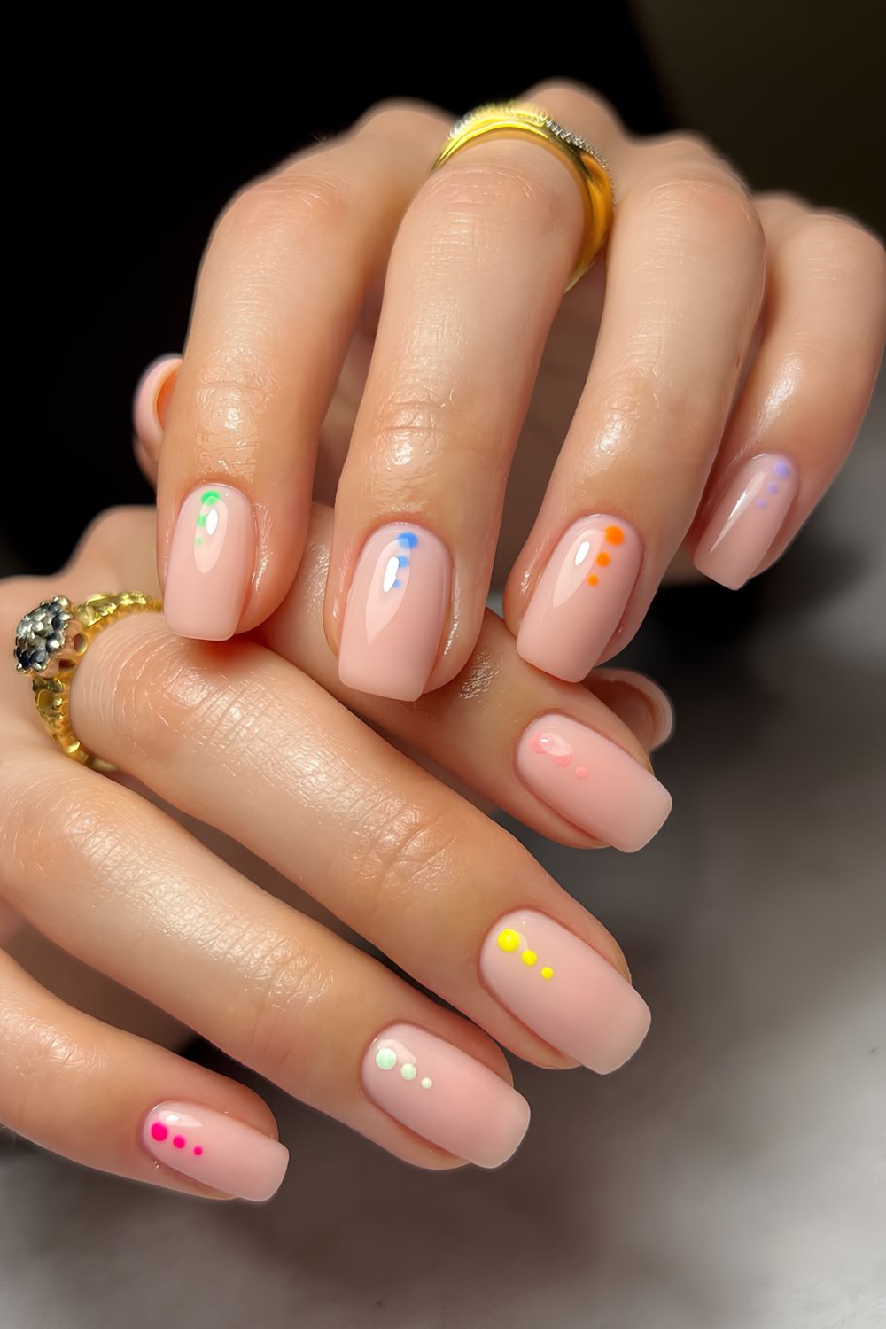 Neutral nails with 3 colorful dots at cuffs