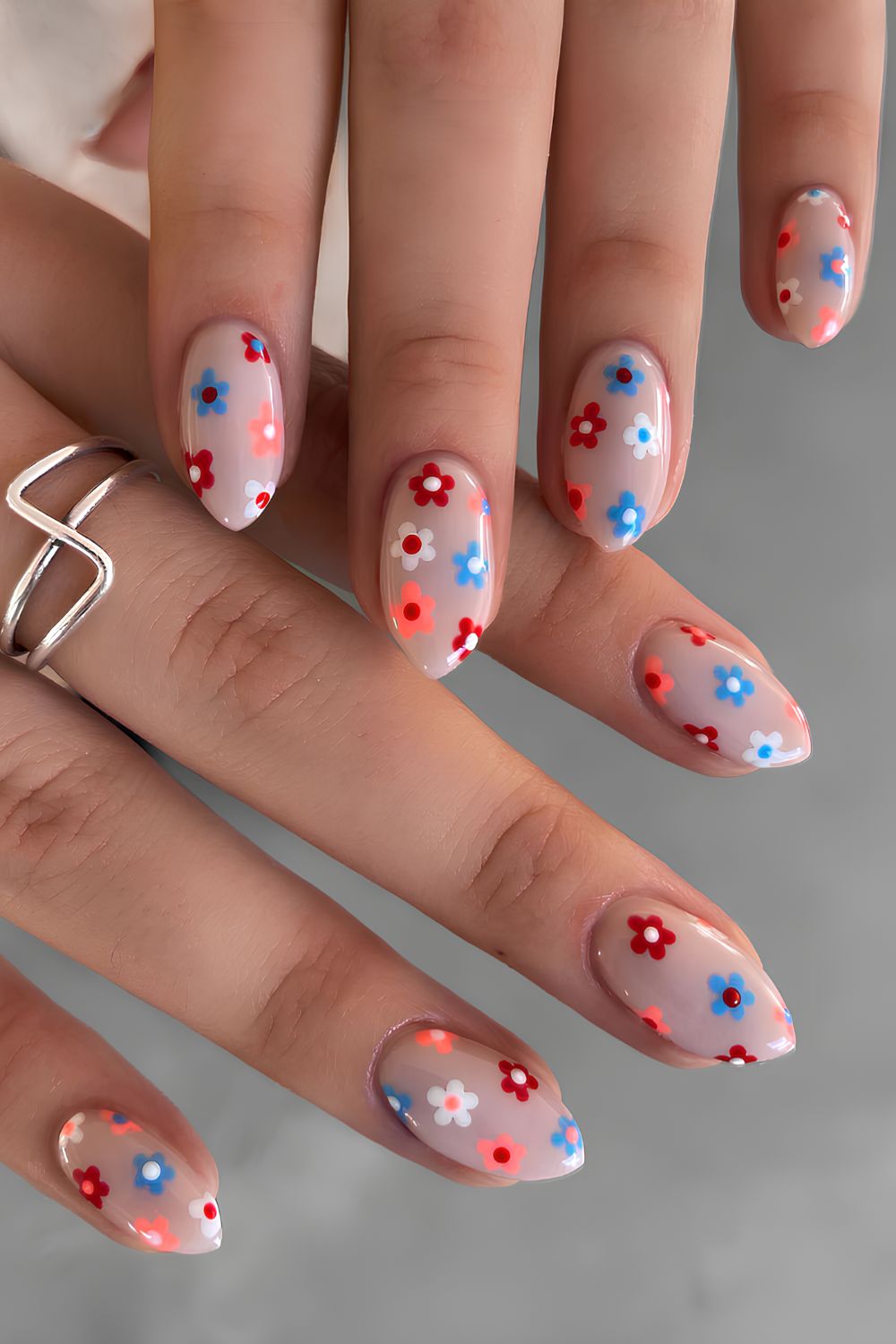 Neutral nails with blue red and white flowers