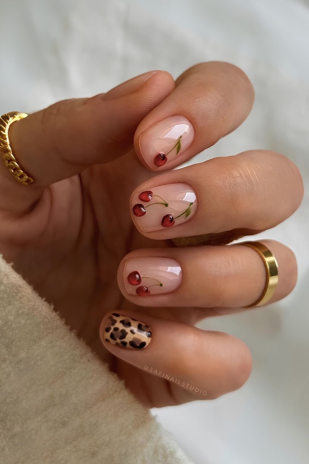 Neutral nails with cheetah print and cherries