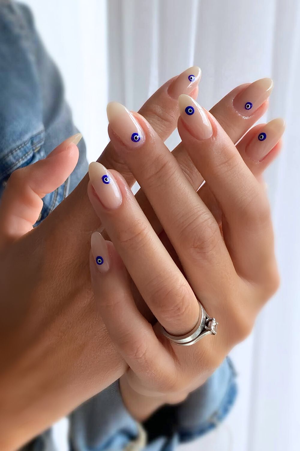 Neutral nails with evil eye decals