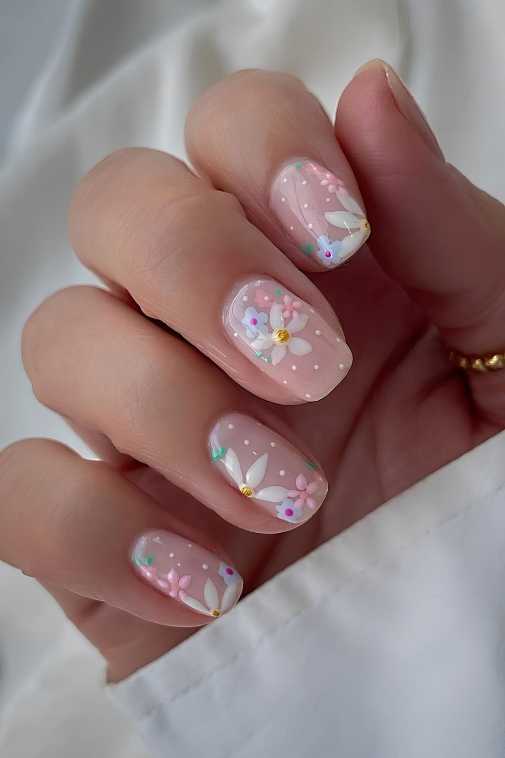 Neutral nails with pastel florals and dots