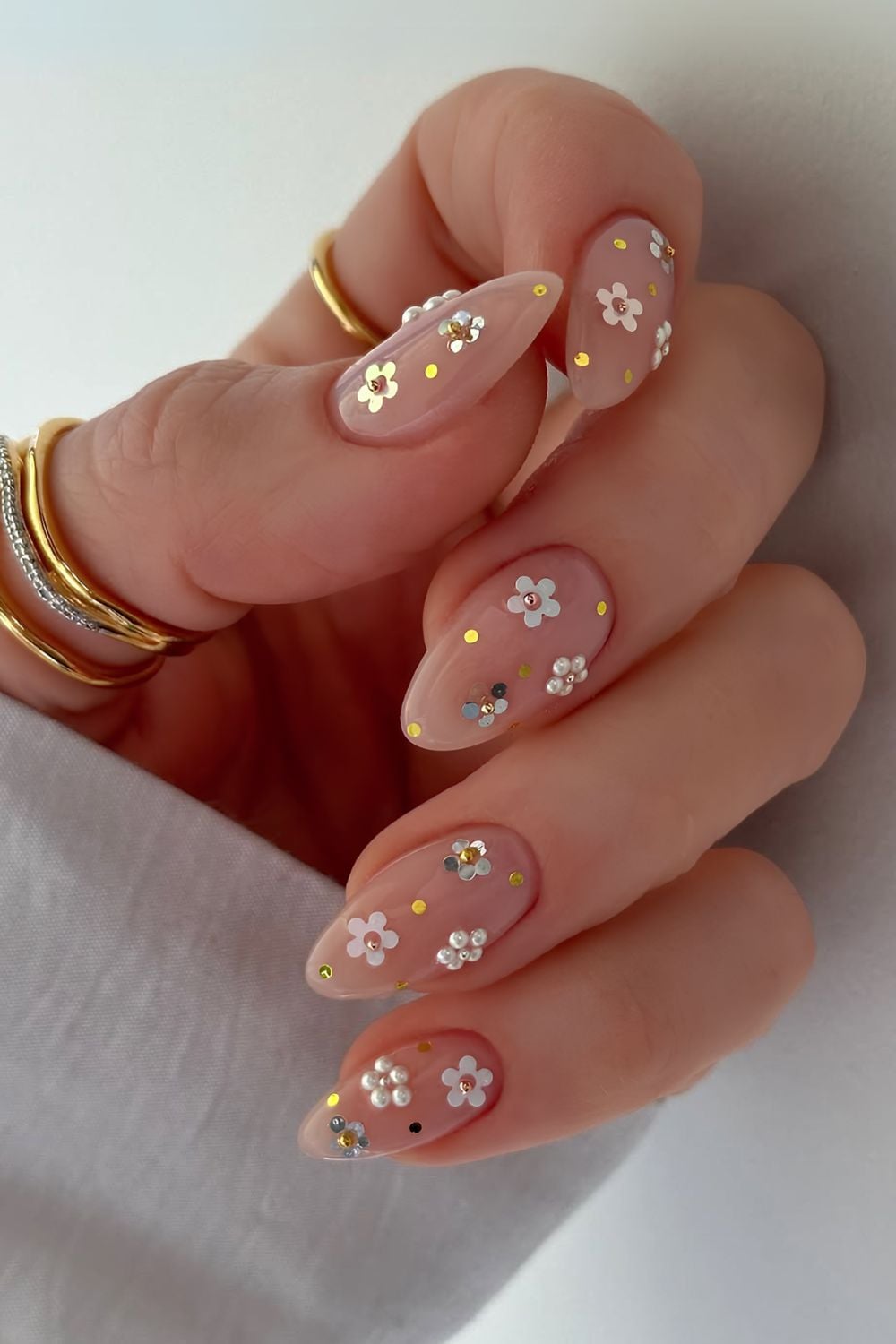 Neutral nails with pearl and glitter floral accents