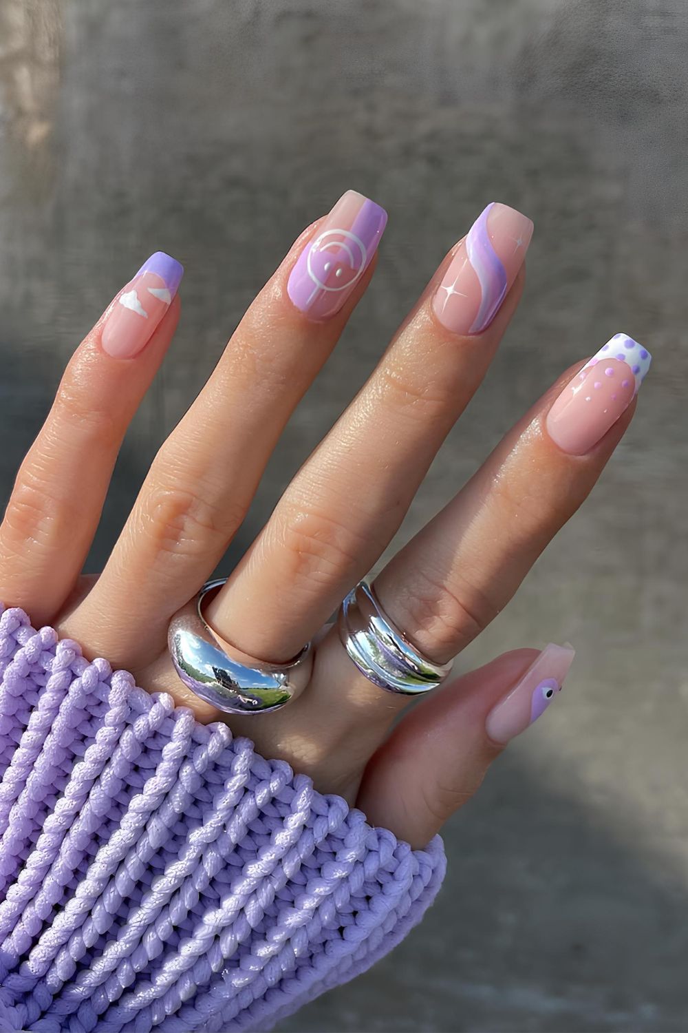 Neutral nails with purple mix and match design