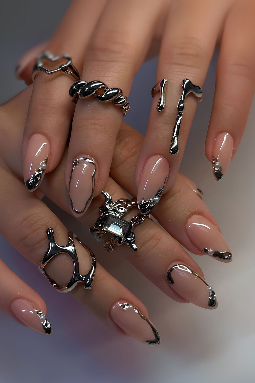 Neutral nails with silver chrome and pearl details