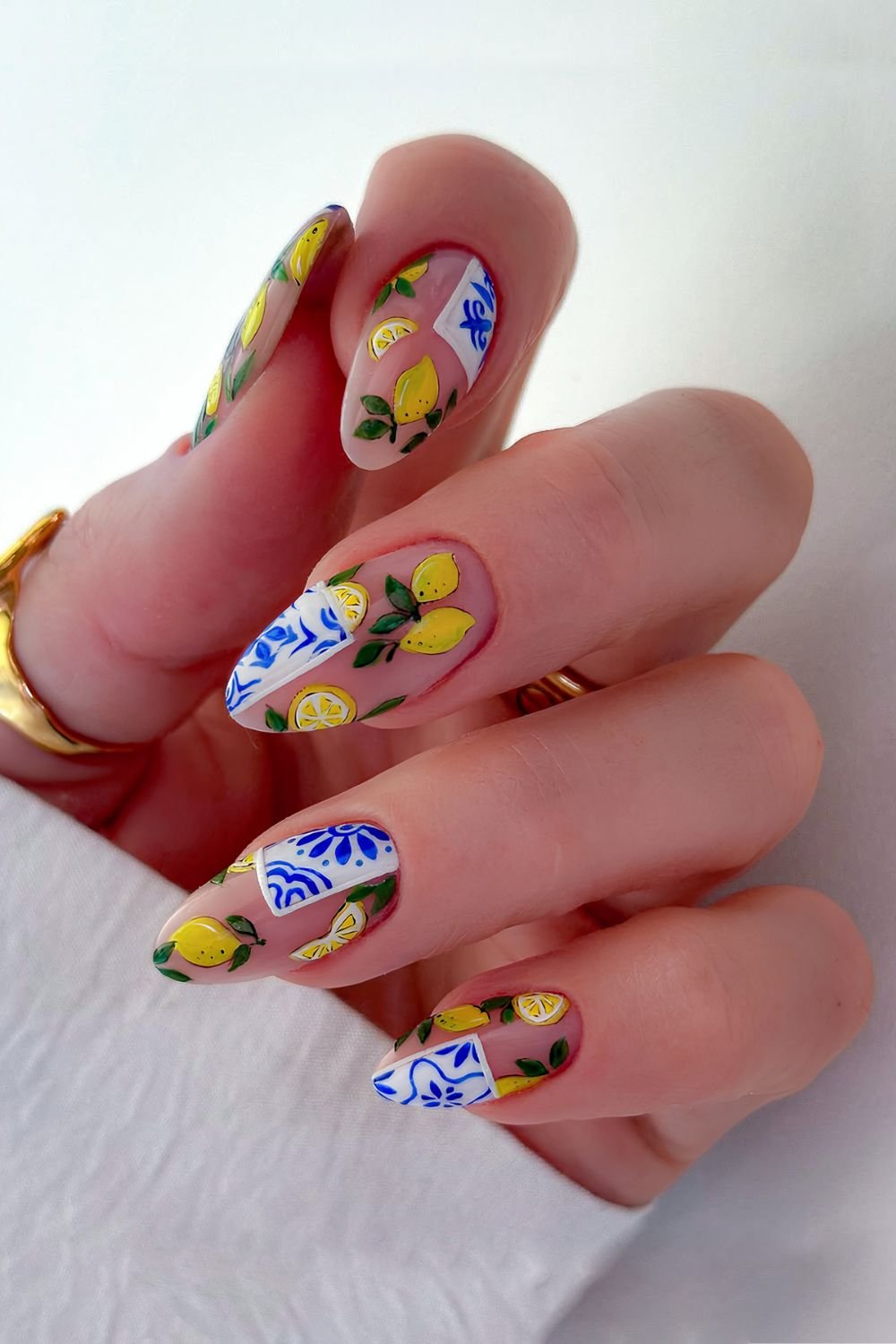 Neutral nails with white and blue mediterranean tile details and lemons