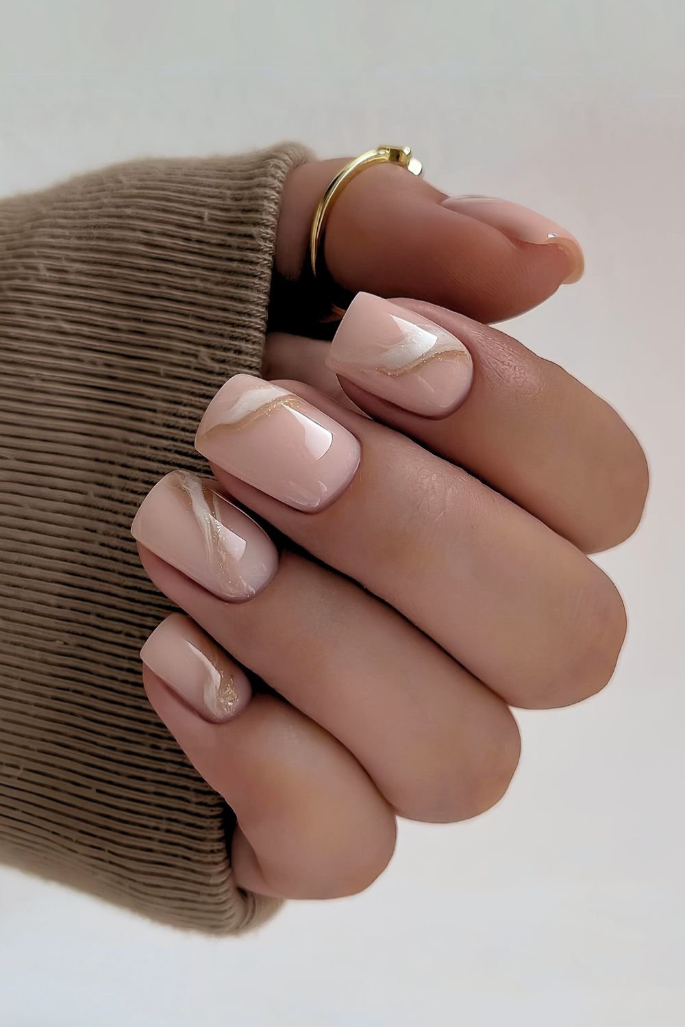 Neutral nails with white and gold swirls