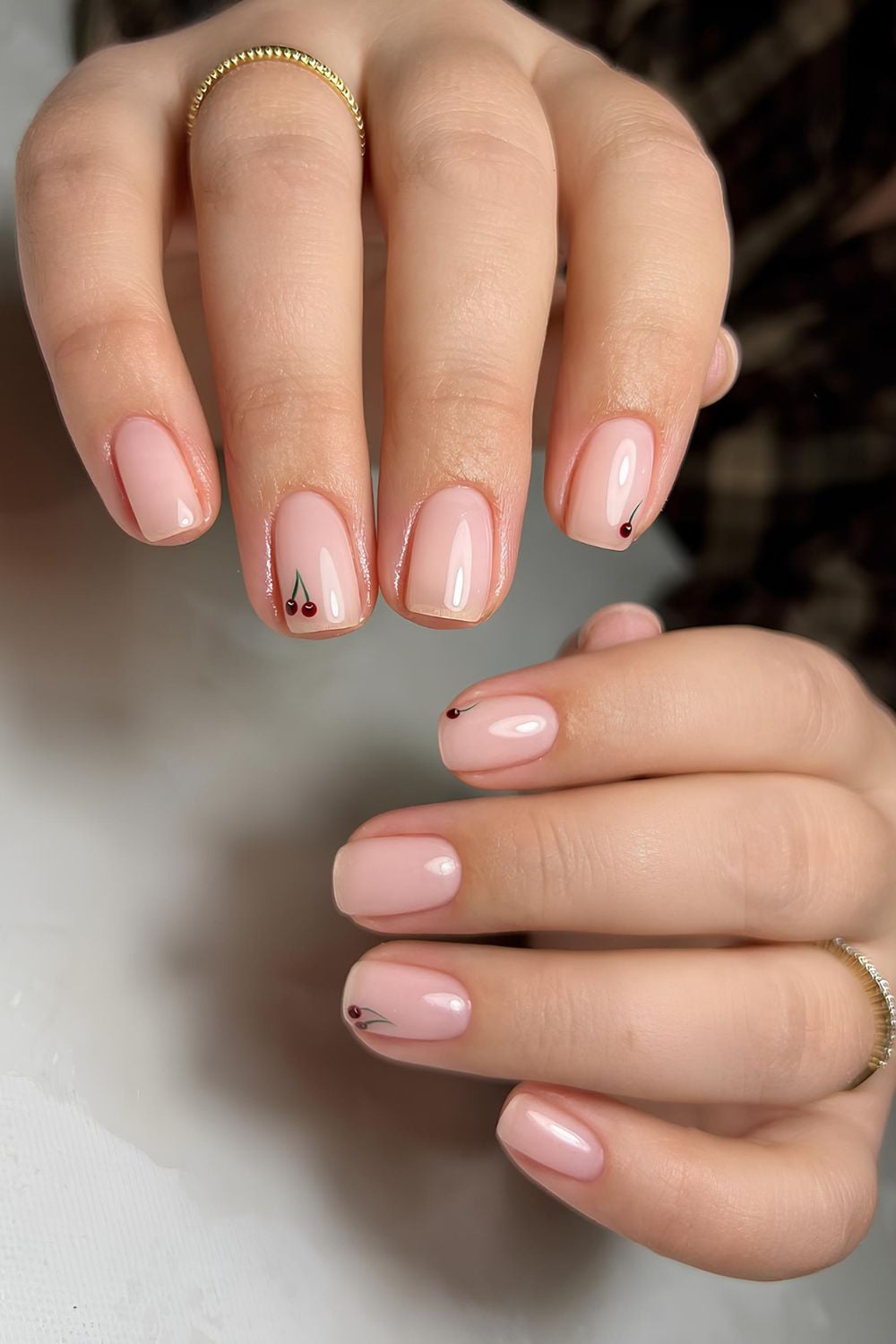 Neutral short nails with tiny cherry accents