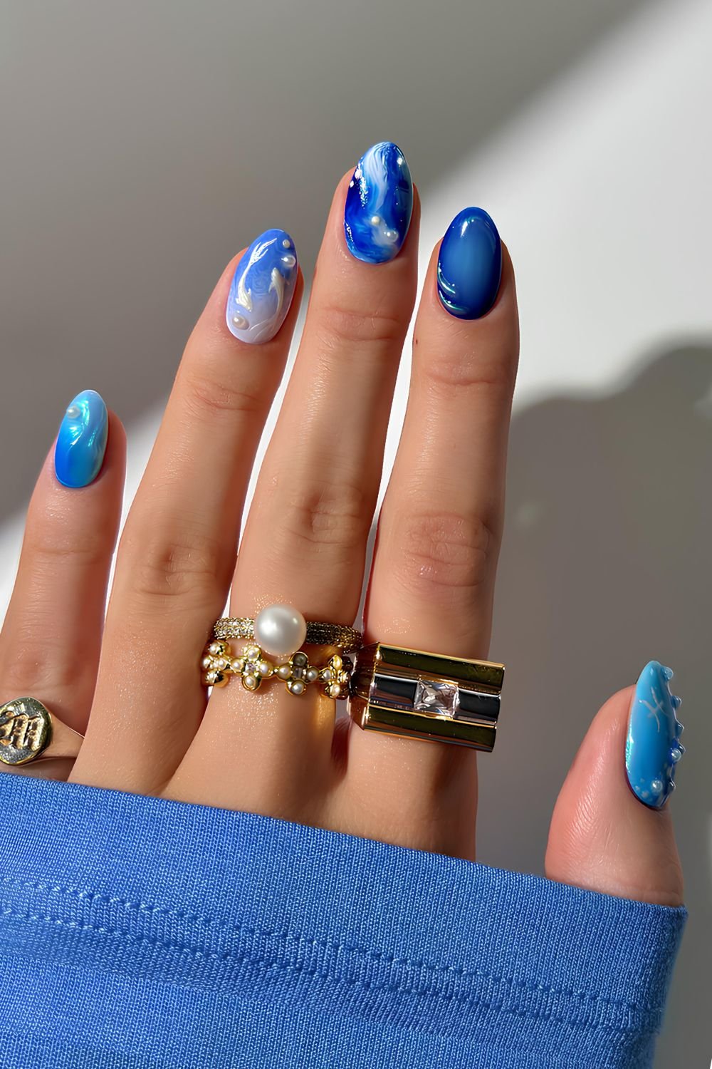 Ocean inspired blu nails with white pearls and fish design