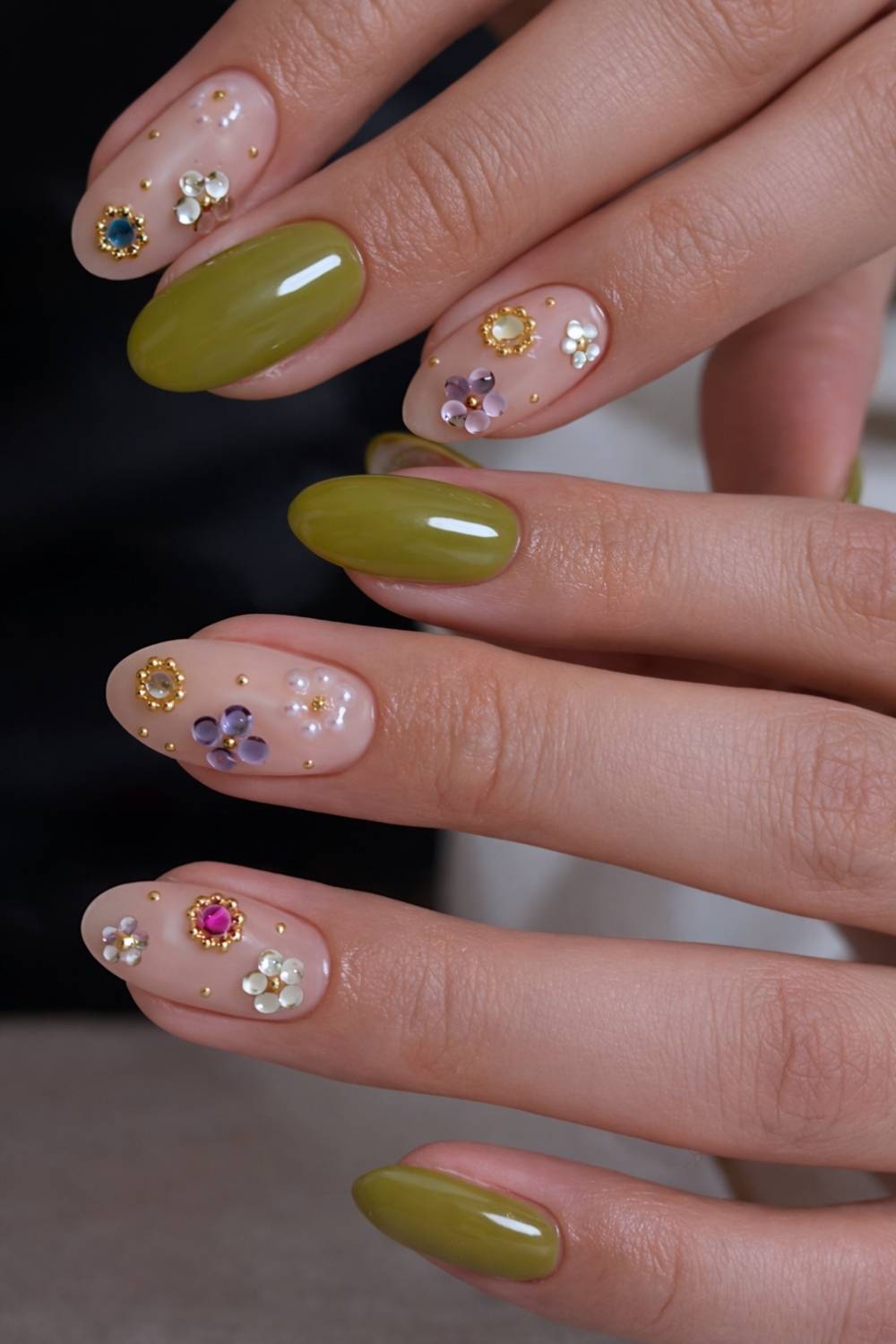 Olive green mani with rhinestone flowers