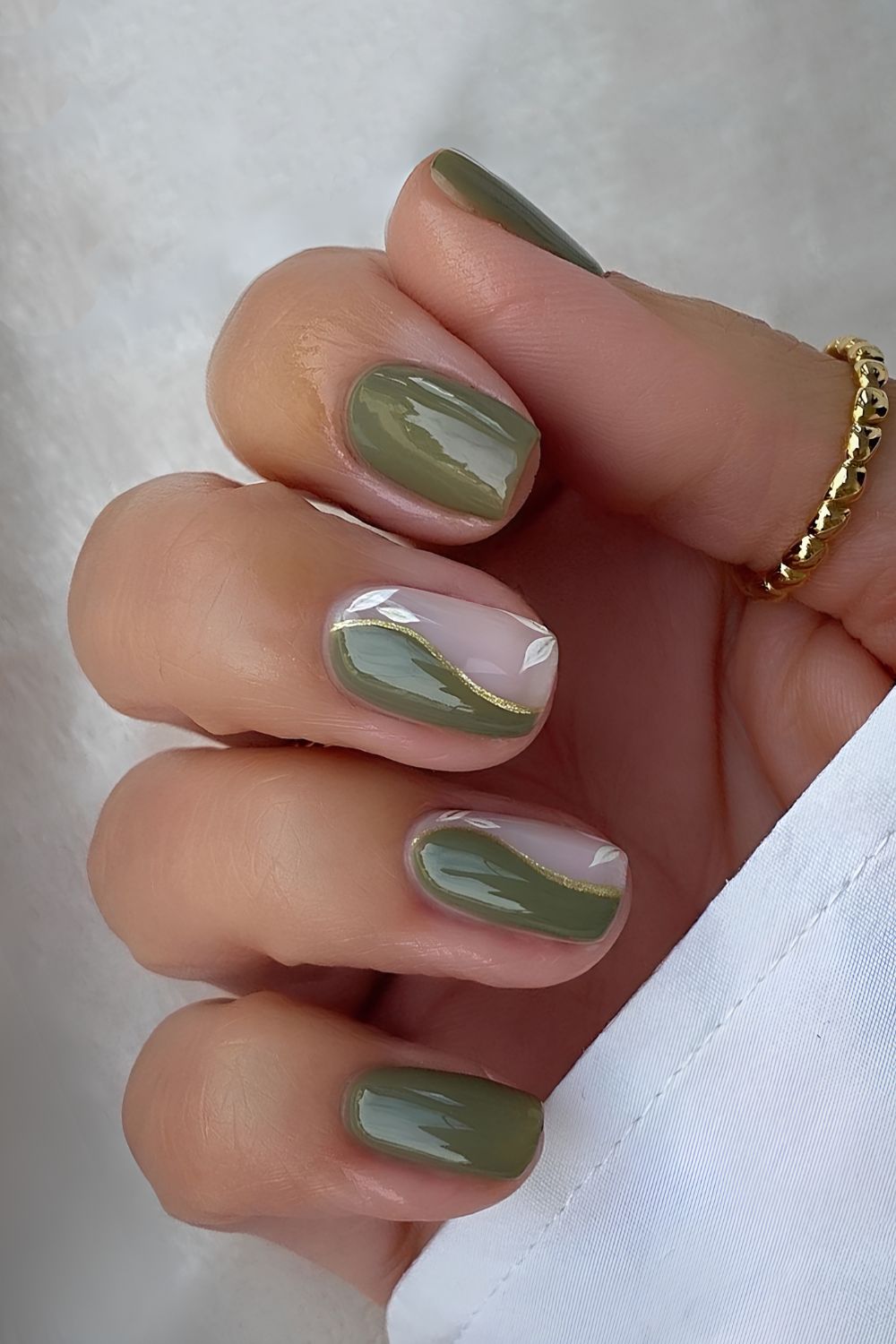 Olive green split swirl nails with gold accents