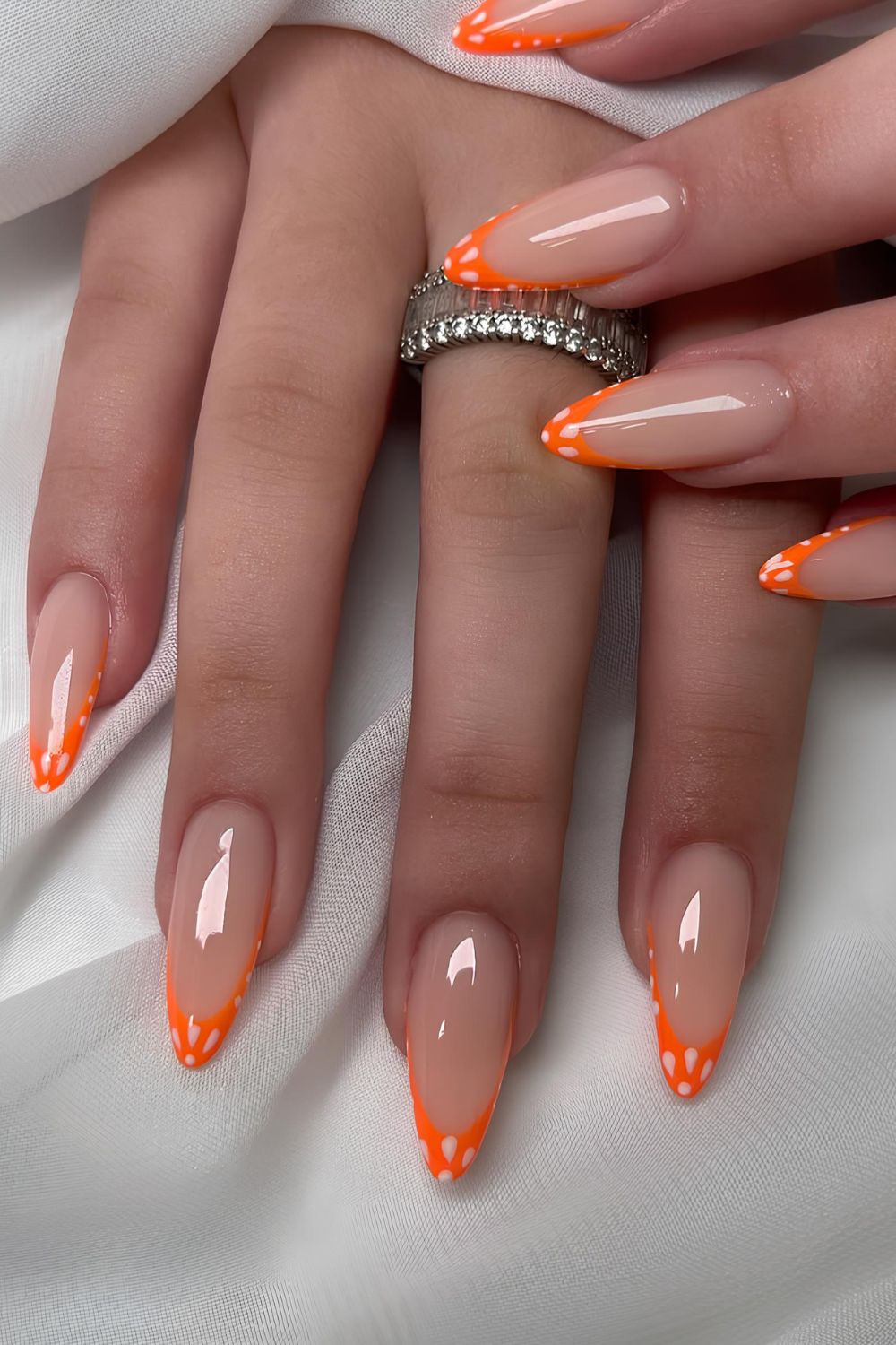 Orange French nails with white petals