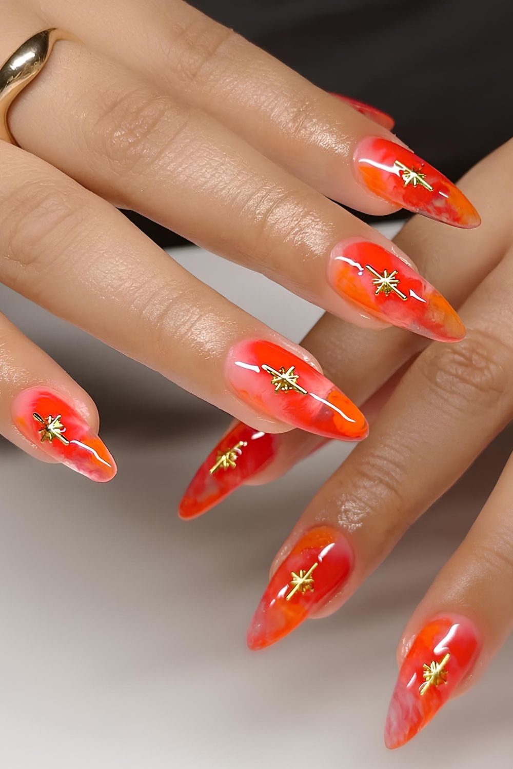 Orange marble mani with gold star accents