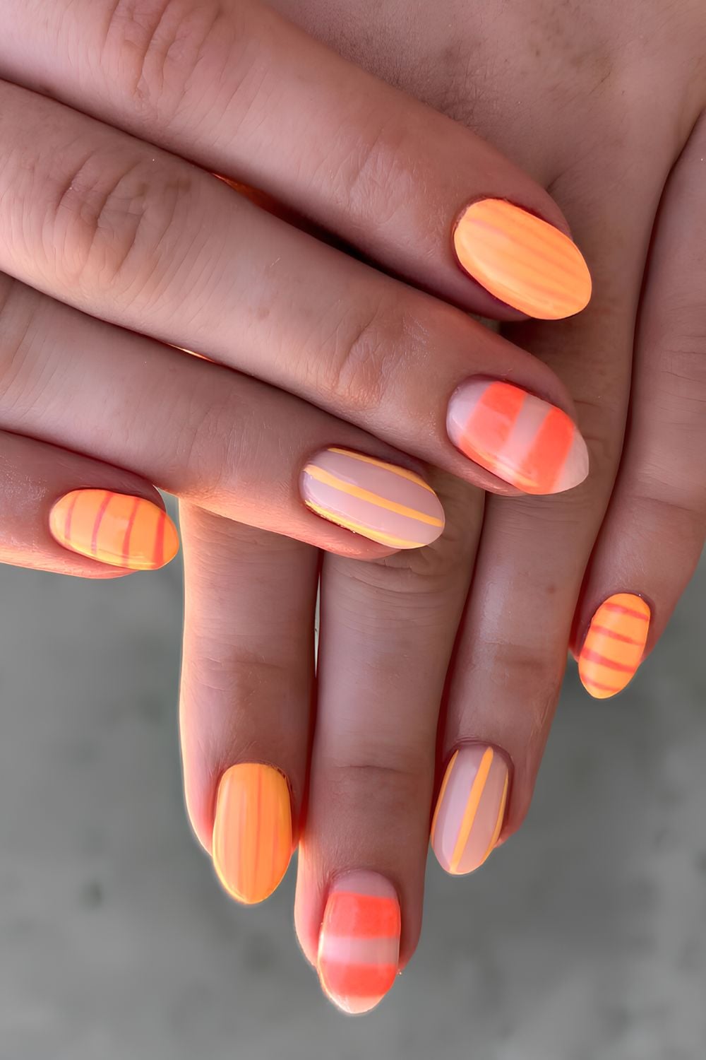 Orange nails with stripe and neon accents