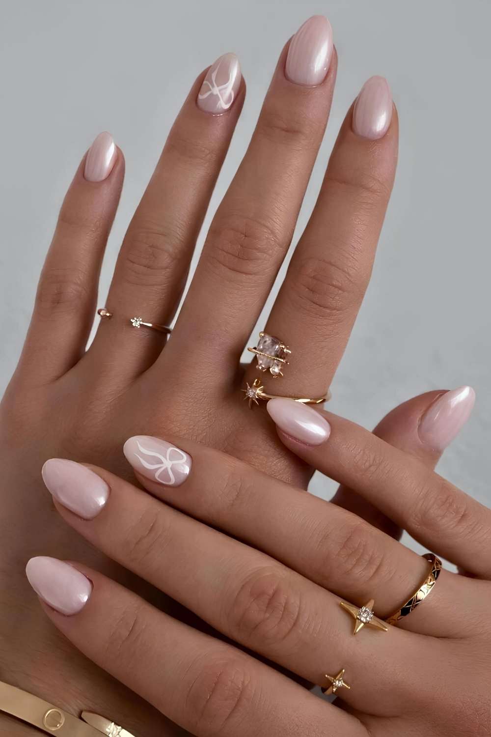 Pale pink chrome mani with bows