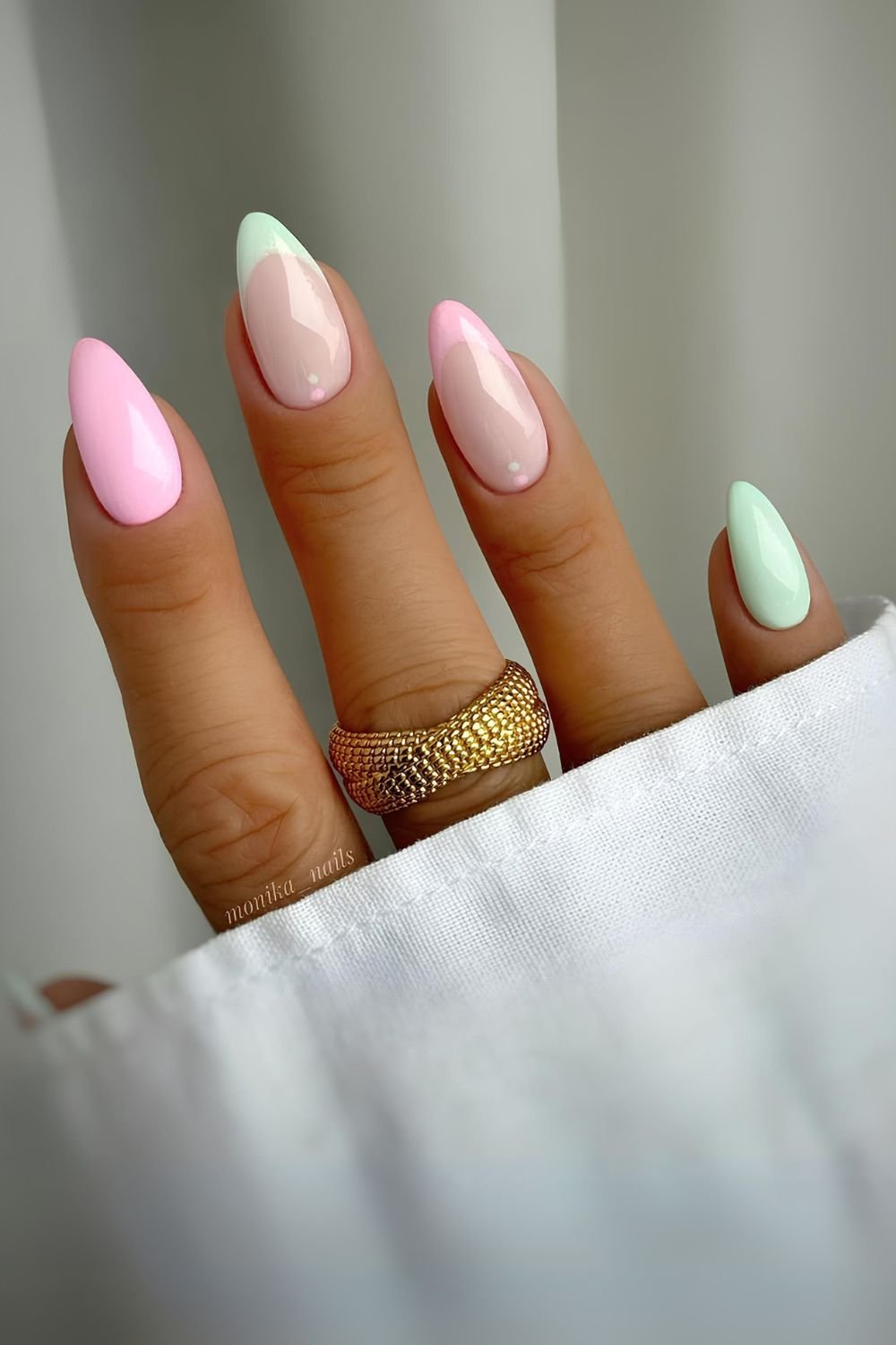 Pastel green and pink nails with dot accents