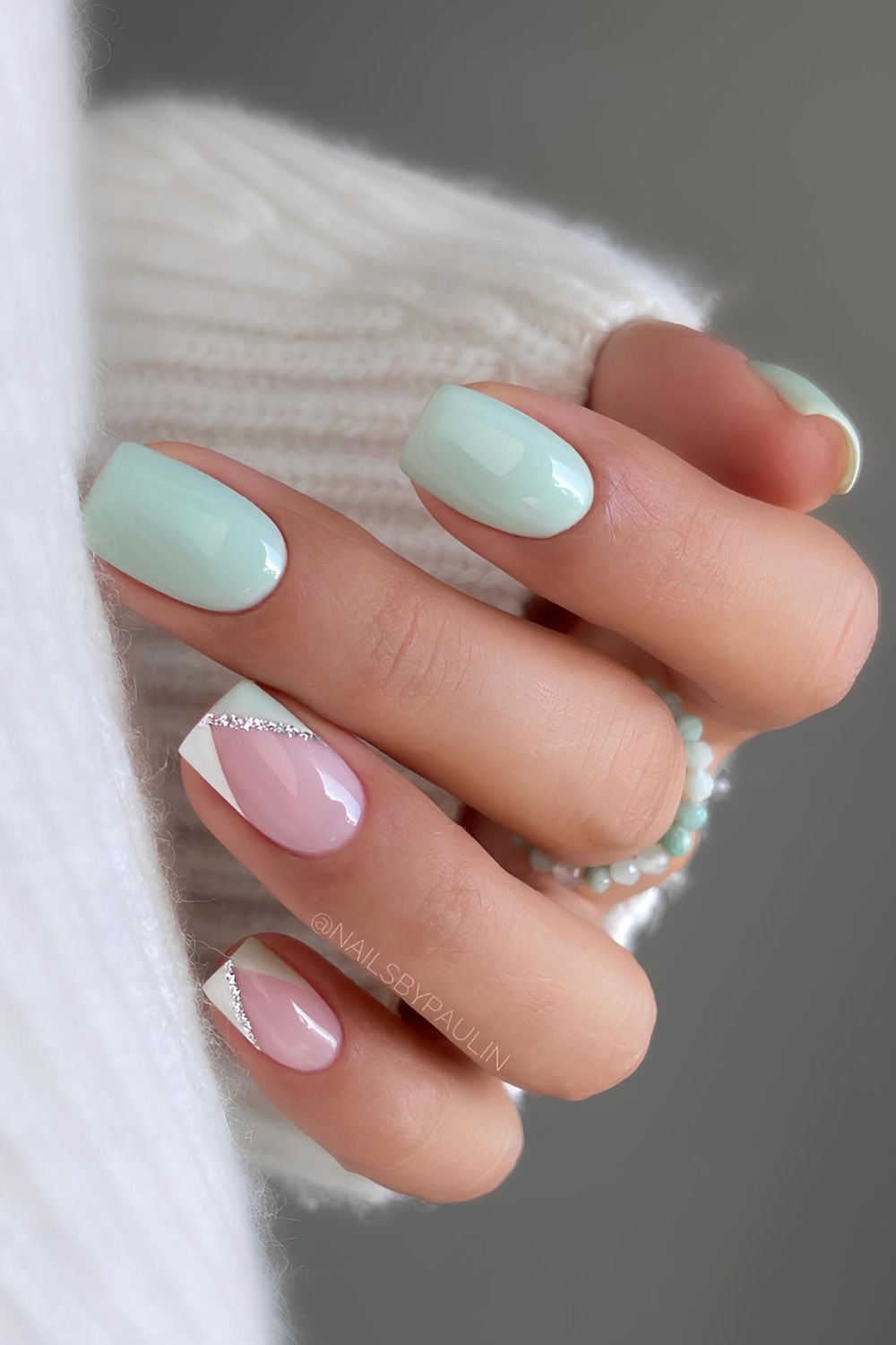 Pastel green and white nail with glitter details
