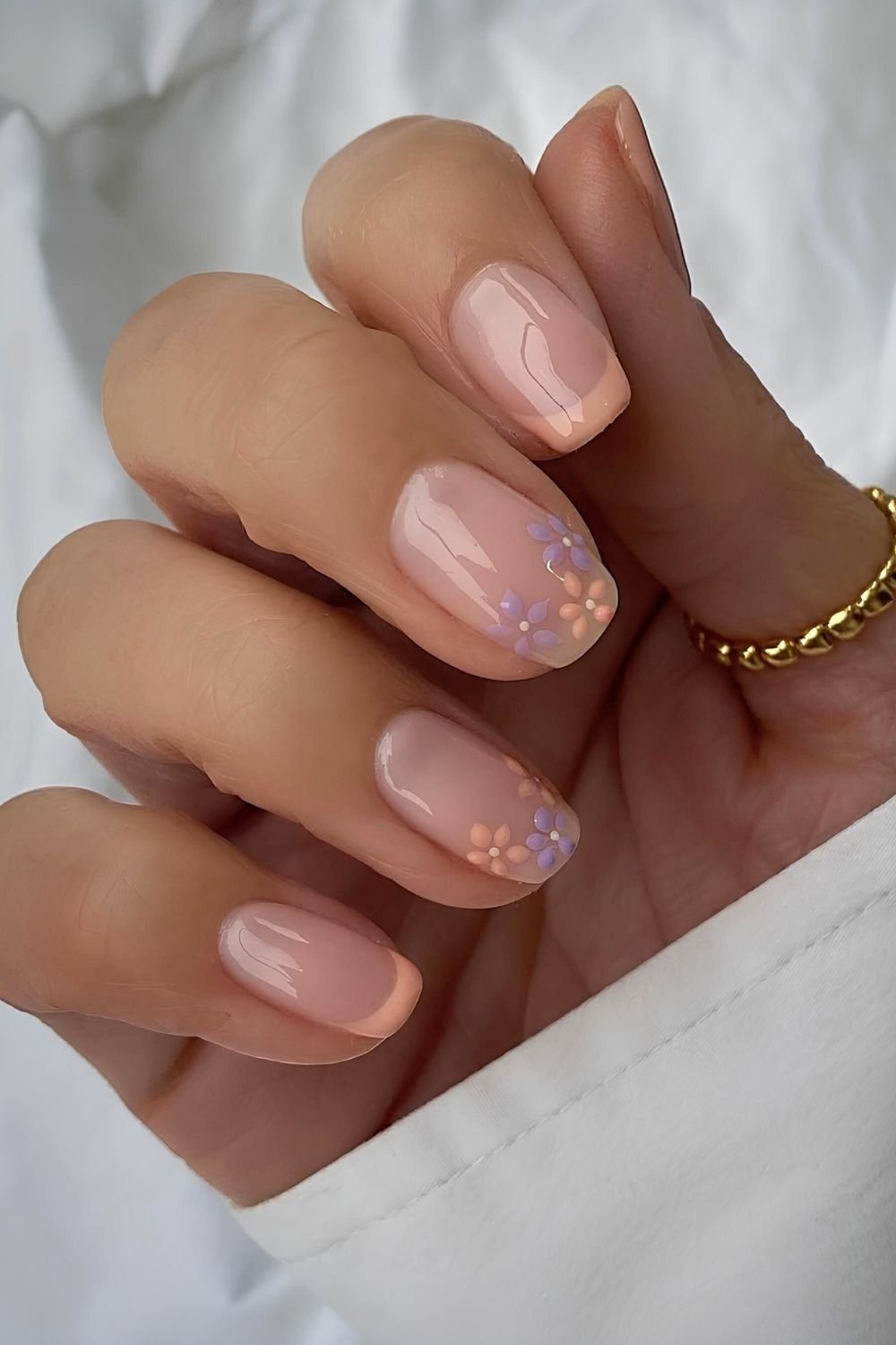 Pastel peachy French nails tih floral accents