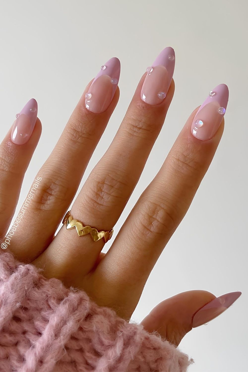 Pastel pink French nails with waterdrop accents
