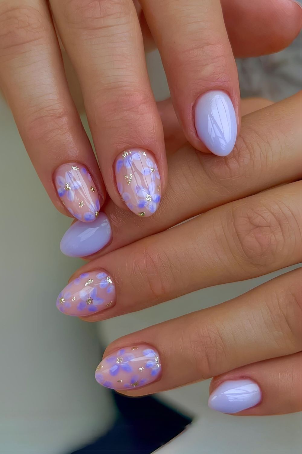 Pastel purple nails with floral and gold foil accents