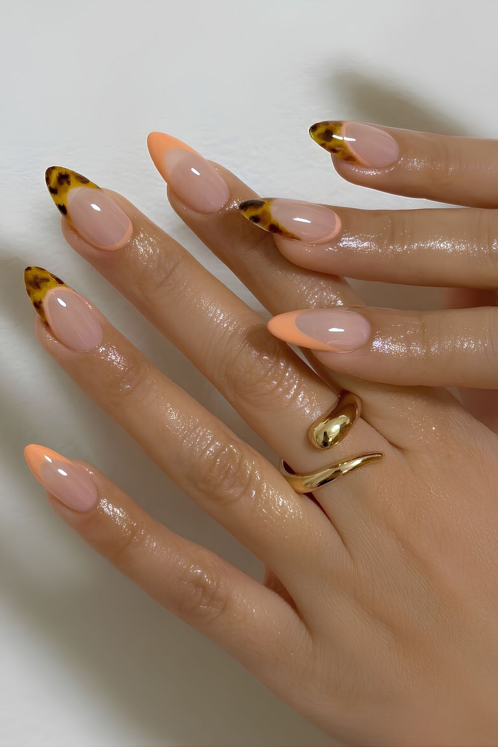 Peach French nails with tortoise shell accents