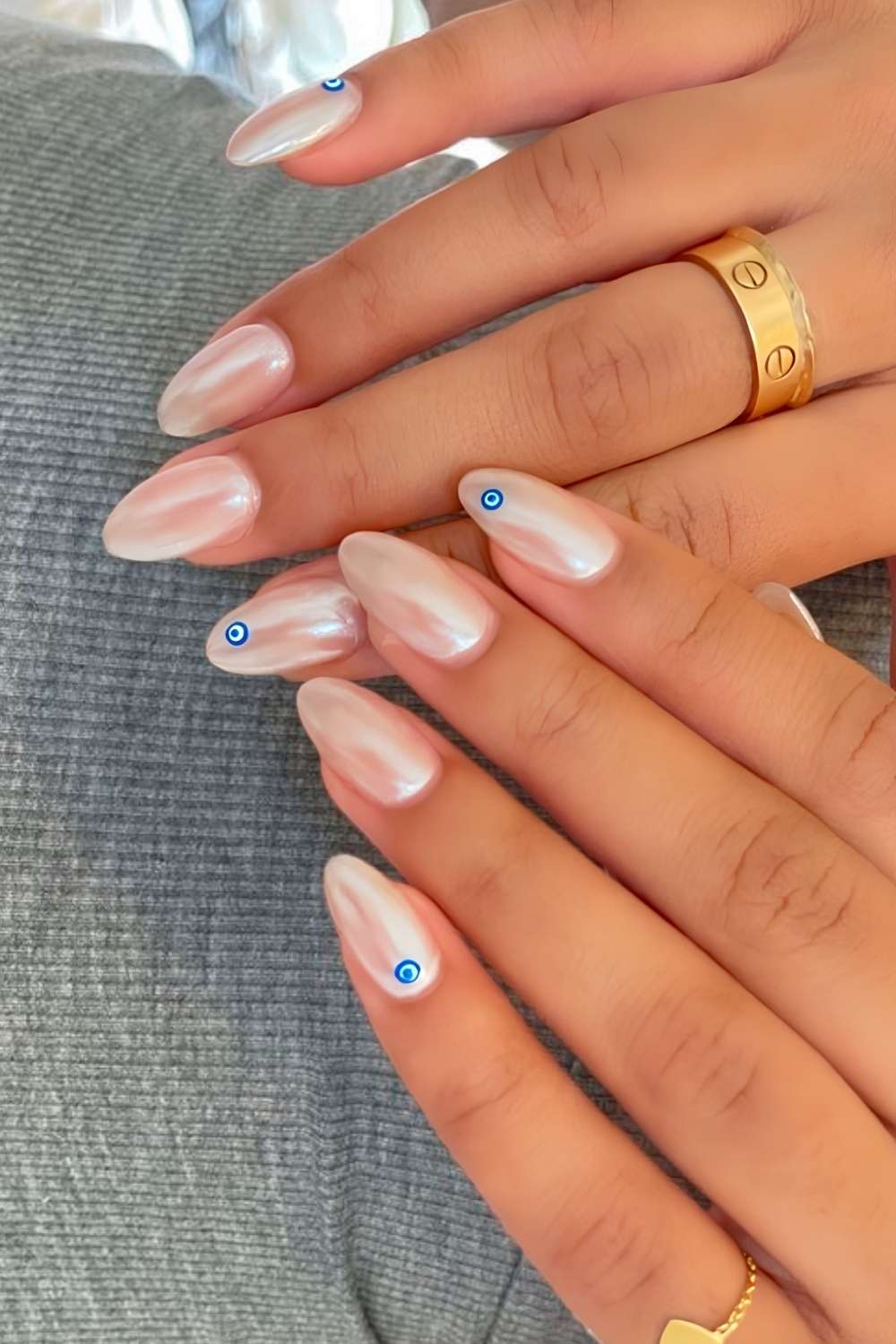 Pearly white chrome nails with evil eye motives