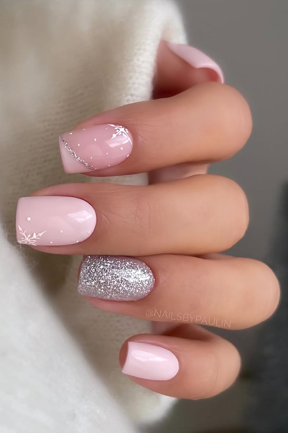 Pink Christmas nails with silver glitter and snowflakes