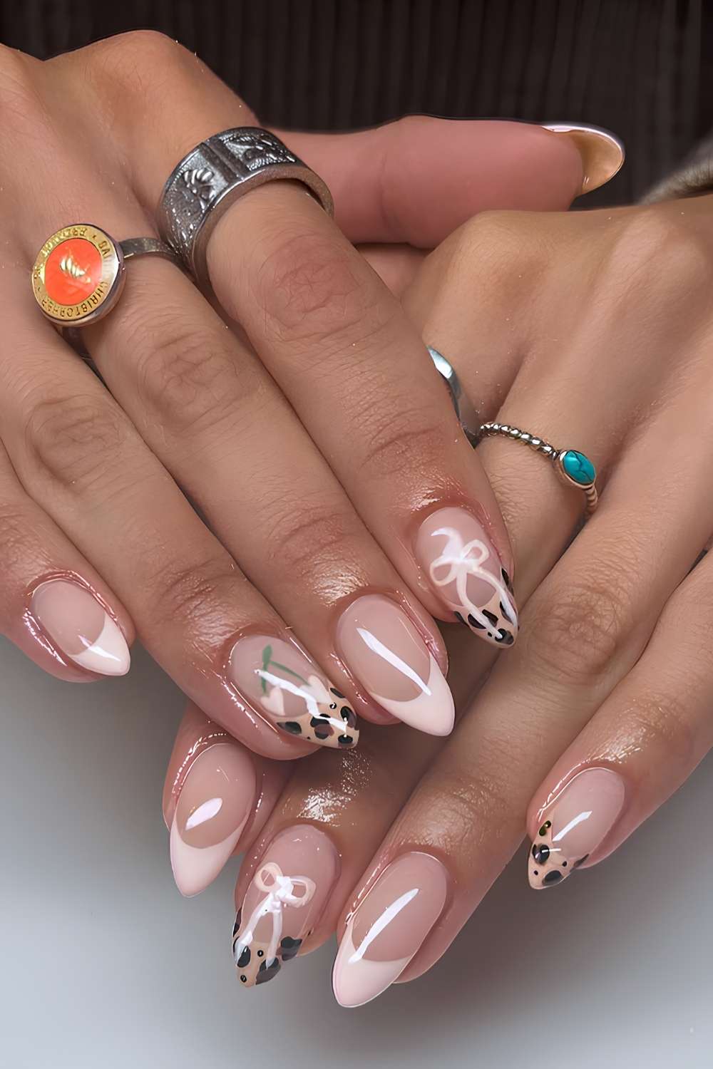 Pink French nails with bows and leopard print