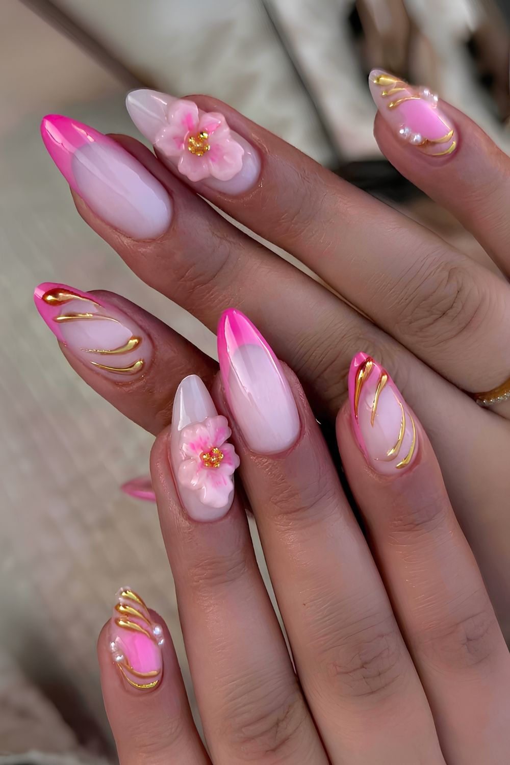 Pink French nails with chrome accents and flowers