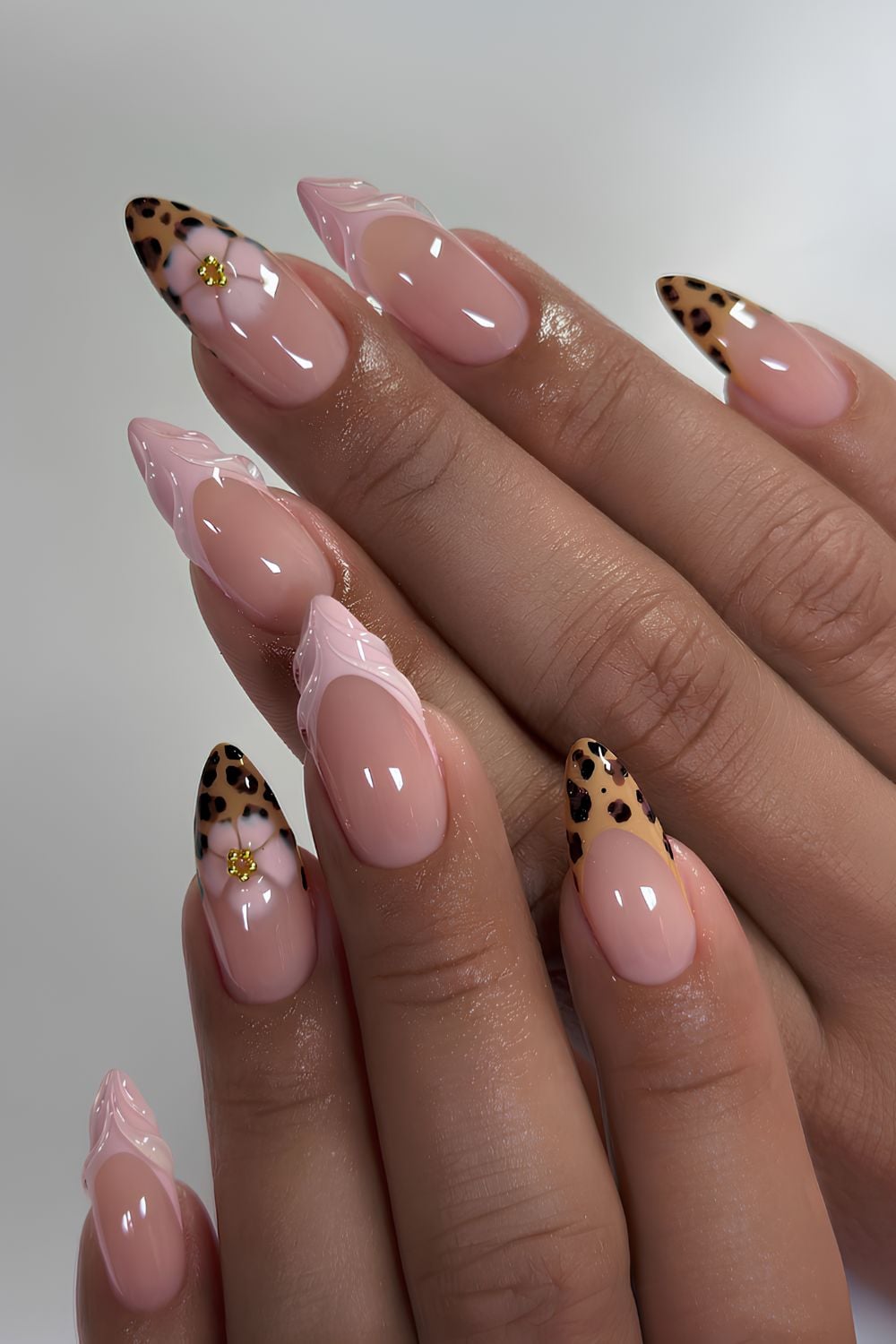 Pink French nails with floral and cheetah print accents