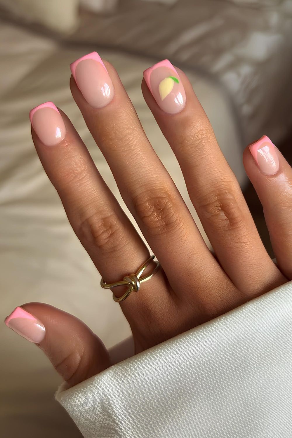 Pink French nails with lemon accents