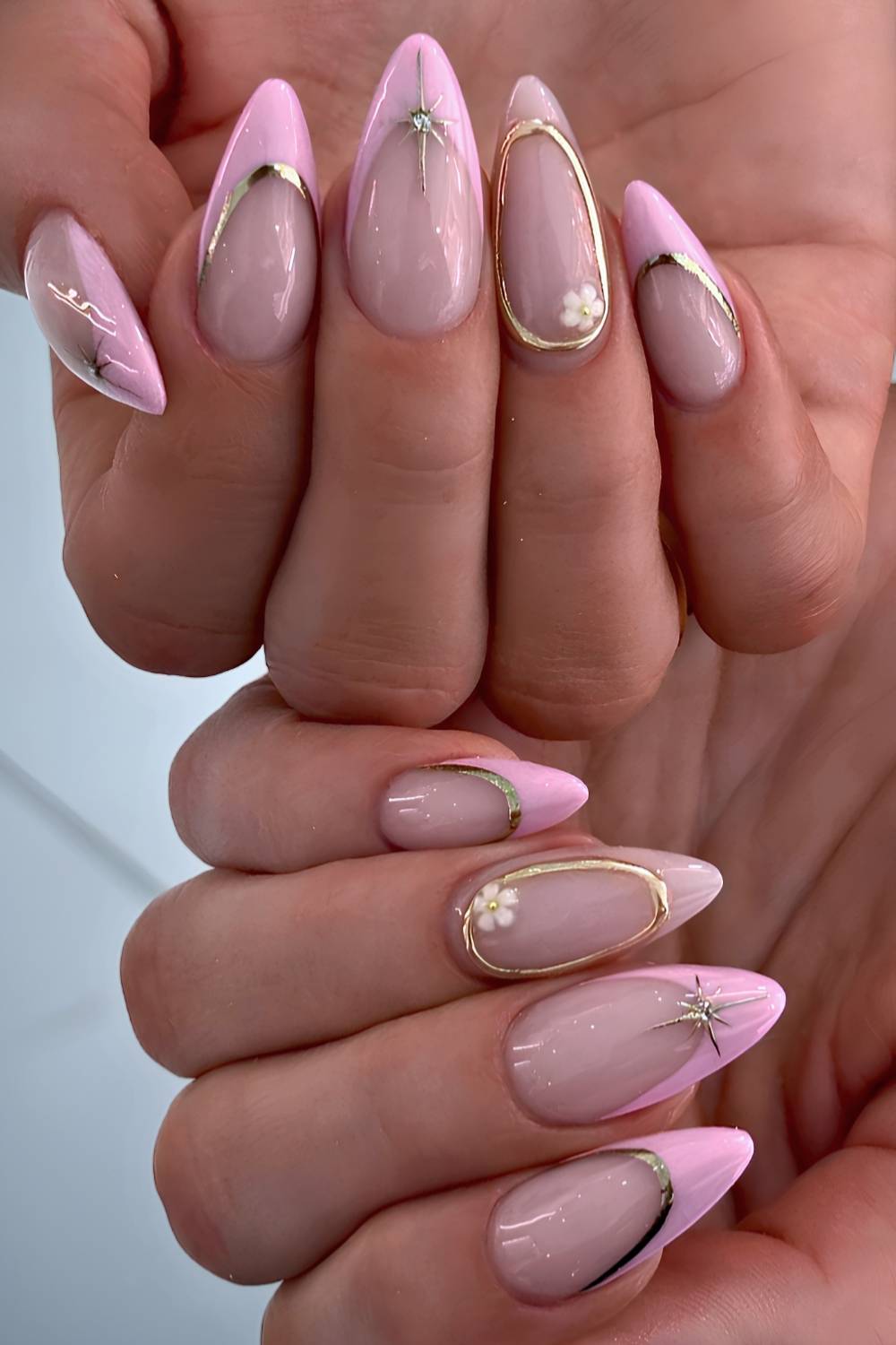 Pink French tip nails with gold detailing