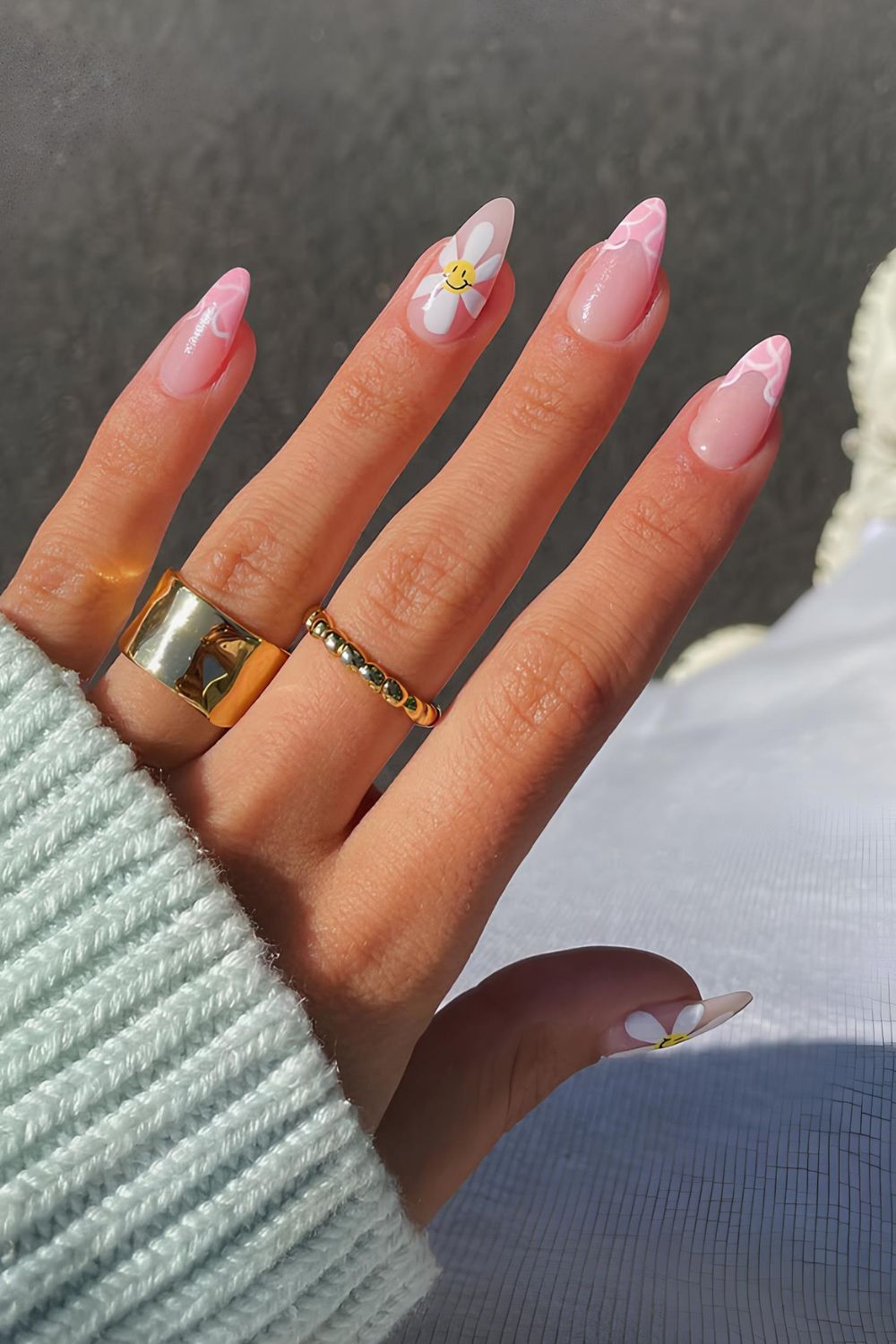 Pink French tips with swirls and daisy accent