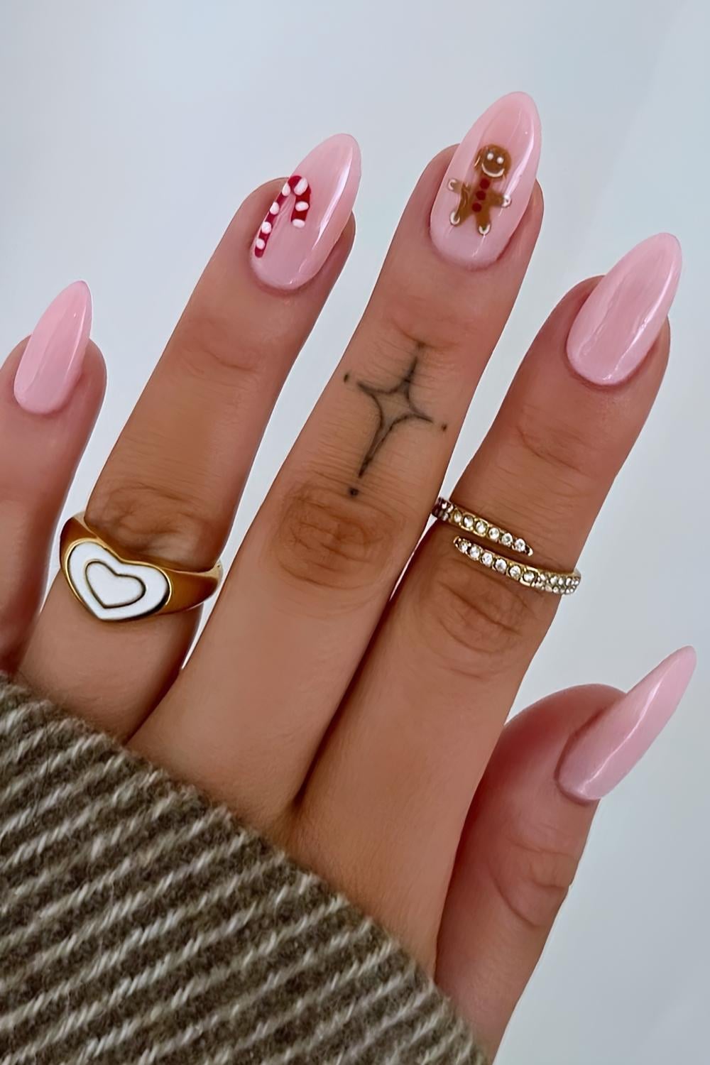 Pink almond nails with gingerbread cookie art